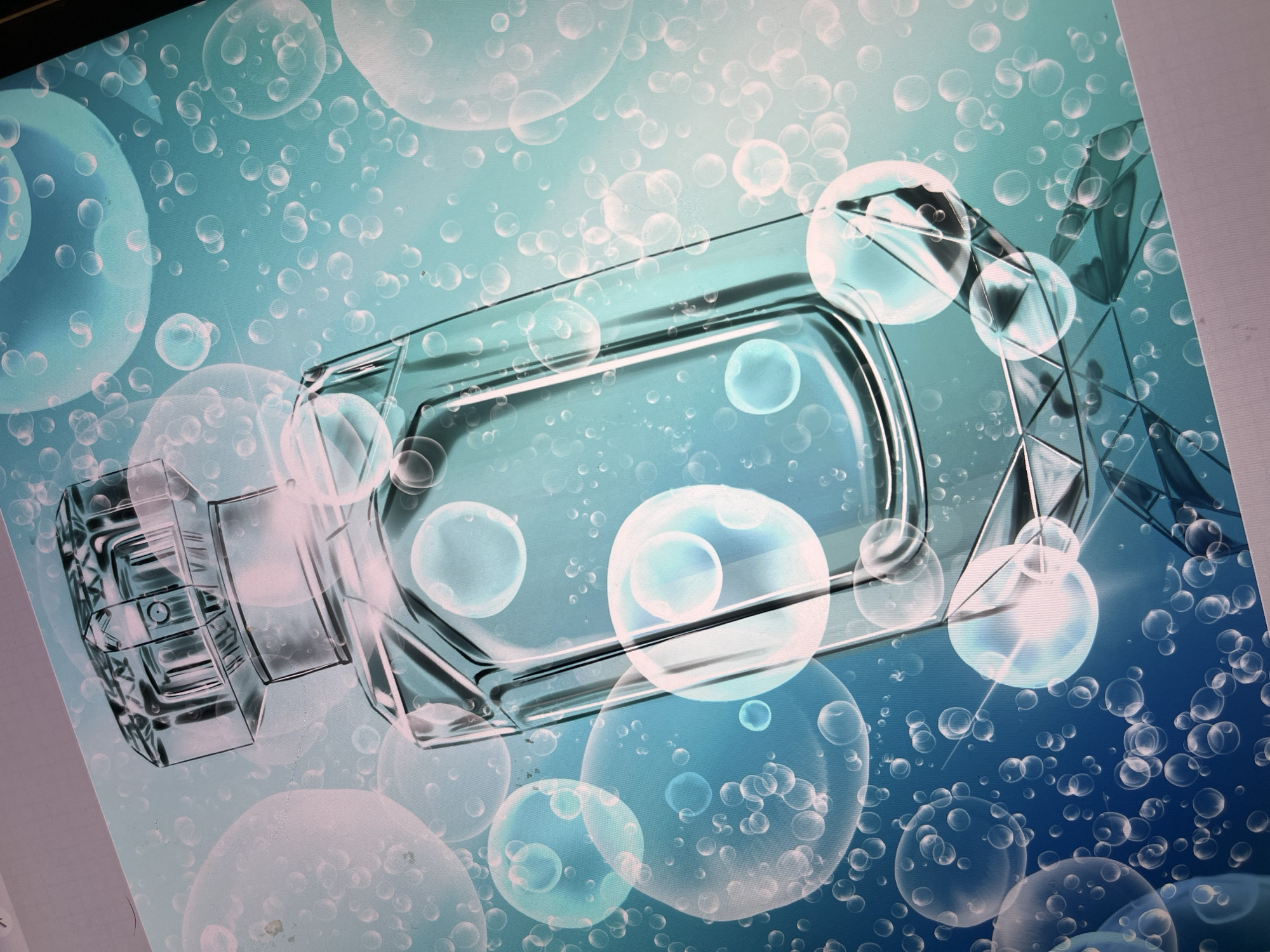 A close-up, angled shot captures a digitally rendered perfume bottle against a teal background filled with numerous bubbles of varying sizes. The bottle, made of clear glass, is rectangular with a faceted geometric base and a detailed, patterned cap. It is positioned slightly off-center, with the cap at the top left and the base extending towards the bottom right. The lighting creates highlights and reflections on the bottle's surface, giving it a glossy appearance. The bubbles, some large and translucent, others small and opaque, are scattered across the entire frame, some appearing to be in front of and behind the bottle, contributing to a sense of depth and a refreshing, aquatic theme. The overall aesthetic suggests a promotional image for a fragrance. The image is a digital rendering on a screen, with a visible light grey border at the bottom.