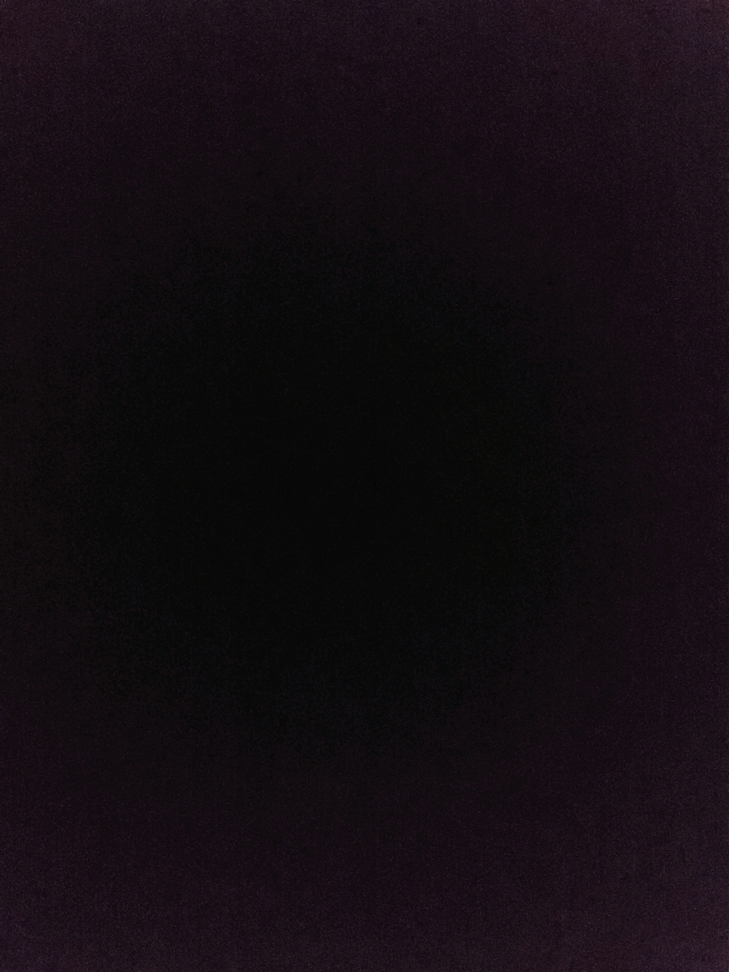 The image displays a dark, textured surface, appearing to be a solid color with subtle variations in shade. There are no discernible objects, people, or environmental features visible. The overall impression is of a close-up shot of a uniform, dark material. The image lacks any context that would associate it with Modhera, Char rasta, or India.