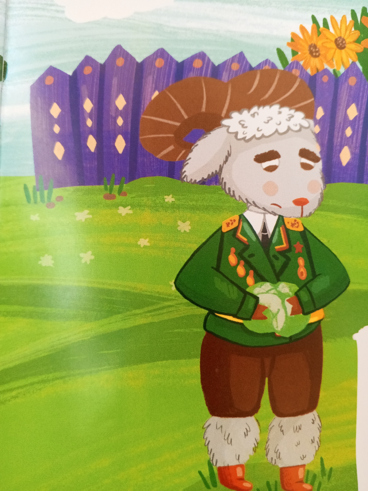 A stylized illustration depicts a ram wearing a green military-style jacket with medals, brown pants, and red boots with fluffy leg warmers. The ram holds a cabbage in its arms. It stands in a grassy area with small white flowers, in front of a purple, pointed fence adorned with diamond shapes and orange circles. Behind the fence, two yellow sunflowers are visible against a pale blue sky. The overall scene is whimsical and illustrative. This image is unrelated to the city of Chistopol, Russia.