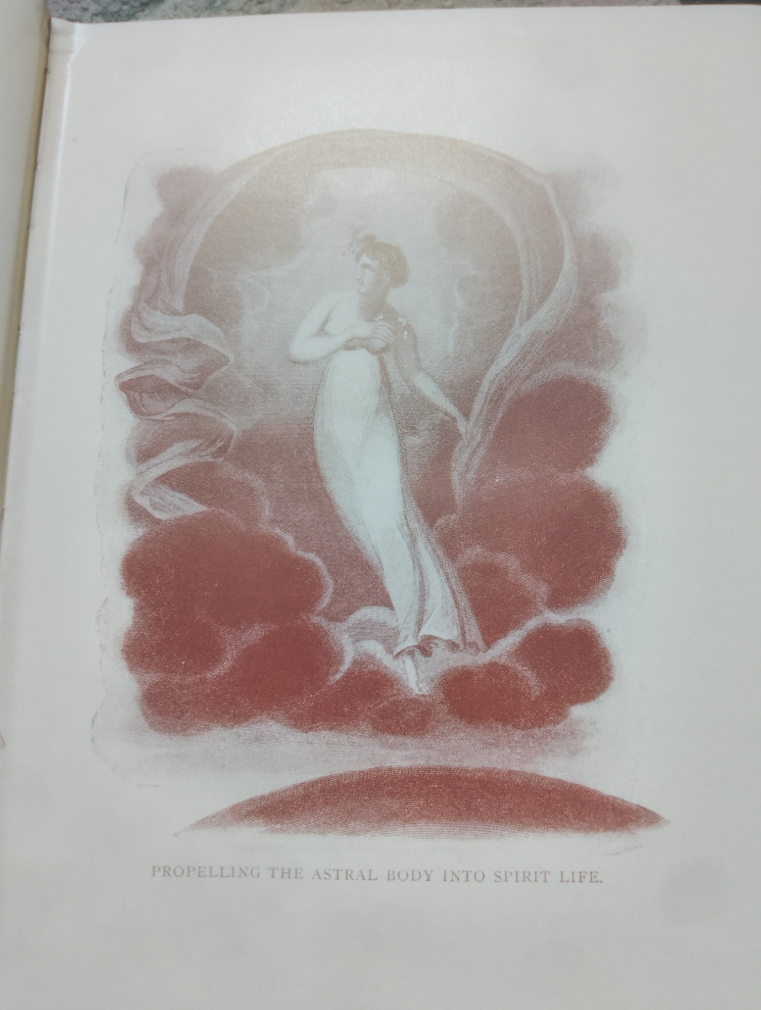 The image is a drawing of a woman in a flowing white garment, appearing to ascend through clouds or mist. She is positioned centrally within the frame, her arms bent and hands held near her chest. A sheer fabric billows around her, creating a sense of movement and etherealness. The background is composed of diffused reddish-brown tones and lighter, hazy areas, suggesting a dreamlike or spiritual setting. Below the drawing, the text "PROPELLING THE ASTRAL BODY INTO SPIRIT LIFE." is printed in a muted grey font.
The provided information does not contain details about Alagbado, Nigeria, and therefore, this aspect cannot be addressed.