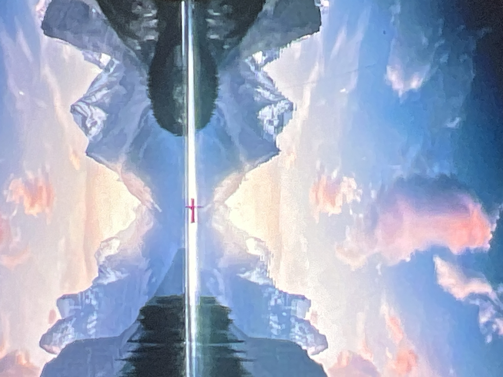 The image depicts a serene mountain lake scene at sunset. Towering, snow-capped mountains with steep inclines dominate the background, their peaks tinged with the soft hues of the setting sun. A dense forest lines the base of the mountains on the left side of the frame. The calm, reflective surface of the lake mirrors the mountains and the sky, creating a symmetrical composition. In the middle of the lake, a small, red kayak with a person in it is the sole sign of human presence. The sky above is painted with pastel colors of pink and orange clouds against a soft blue gradient, which are also reflected in the water below. The overall atmosphere is tranquil and picturesque.