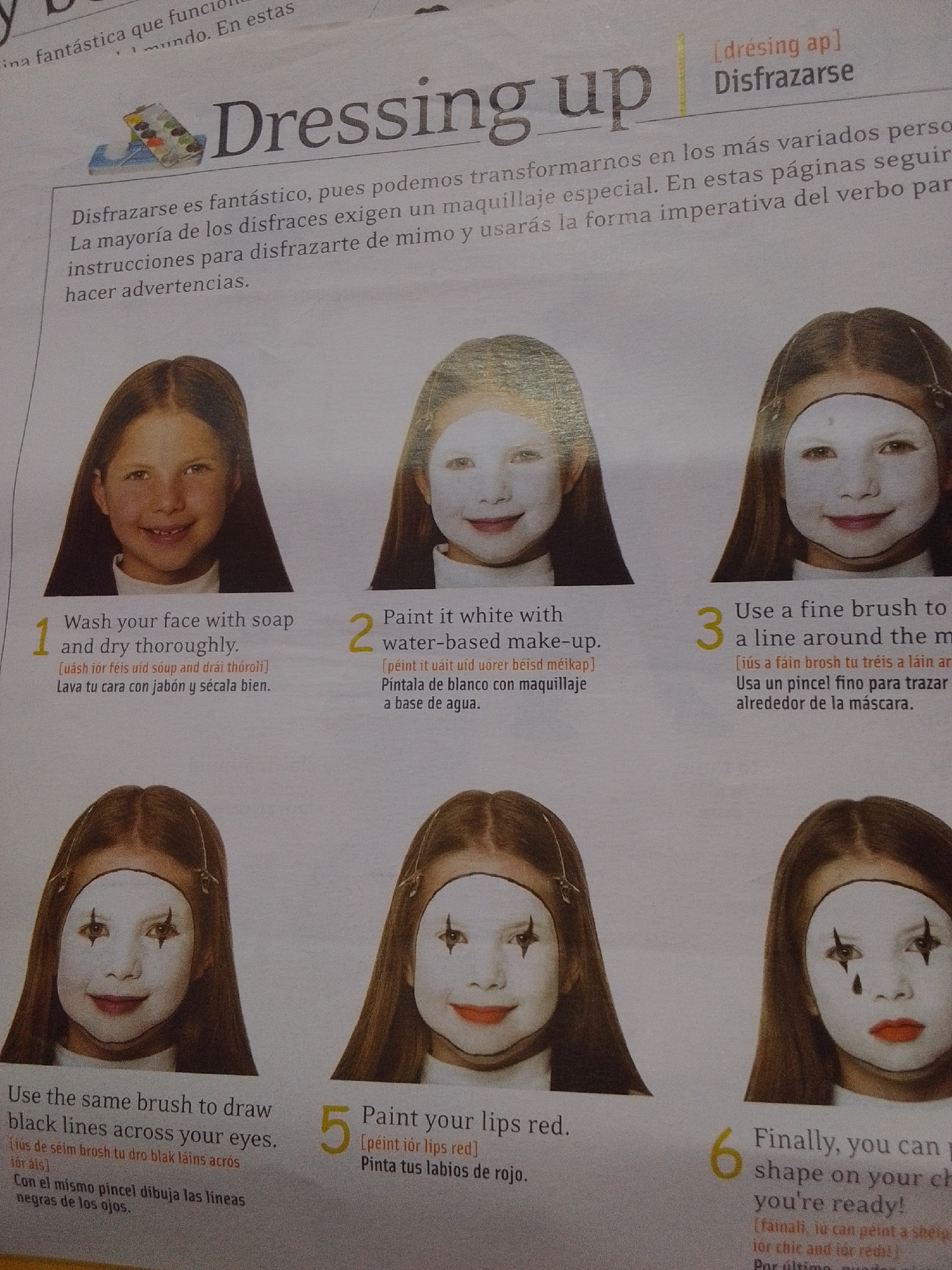 The image displays a magazine page featuring a guide to face painting for dressing up. The title "Dressing up" is prominently displayed, along with the Spanish translation "Disfracarse." The page contains text in English and Spanish, accompanied by six numbered images of young girls demonstrating different stages of face painting.
The first image shows a girl with a clean face. Subsequent images illustrate the application of white makeup, drawing lines around the eyes, and painting lips red. The final image depicts a completed face paint design, possibly resembling a clown or a mime.
The text provides instructions for each step, including phonetic spellings and translations. It suggests using soap and water to wash the face, applying white water-based makeup, and using a fine brush for detailed work. The guide also advises on drawing black lines and painting lips red, concluding with a statement that the face paint design is complete and ready.
There is no information in the image that indicates a location in the city of La Tagua, Venezuela. The context is that of a magazine or educational material.