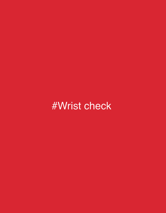 The image displays the text "#Wrist check" in white, sans-serif font centered on a solid red background. There is no discernible urban environment or location specified within the image.