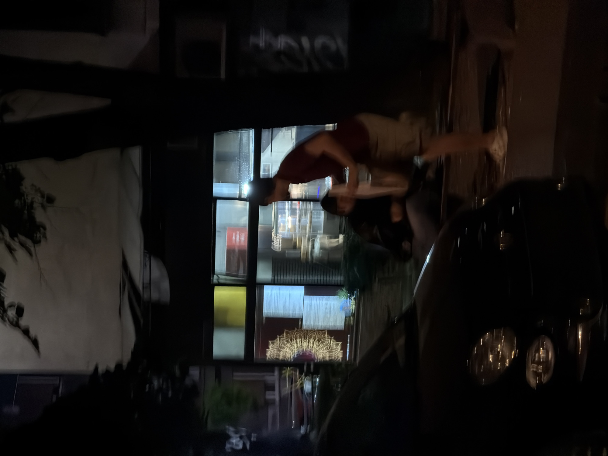 The image shows a person delivering food on the street at night, likely near a restaurant. In front of the restaurant, a car is parked on the street.
It is difficult to say whether or not this image was taken in Vracar Urban Municipality, Serbia.