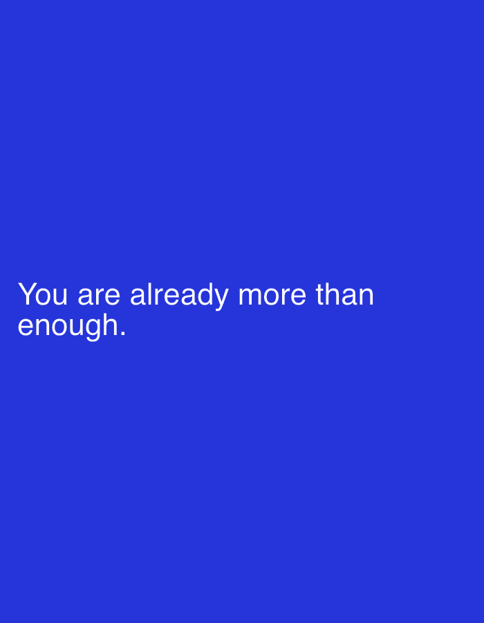The image is a plain blue background with white text that reads "You are already more than enough." There is no identifiable location within the city of Thira Municipal Unit, Greece, or any people, subjects, objects, or actions depicted. The image is purely typographic.