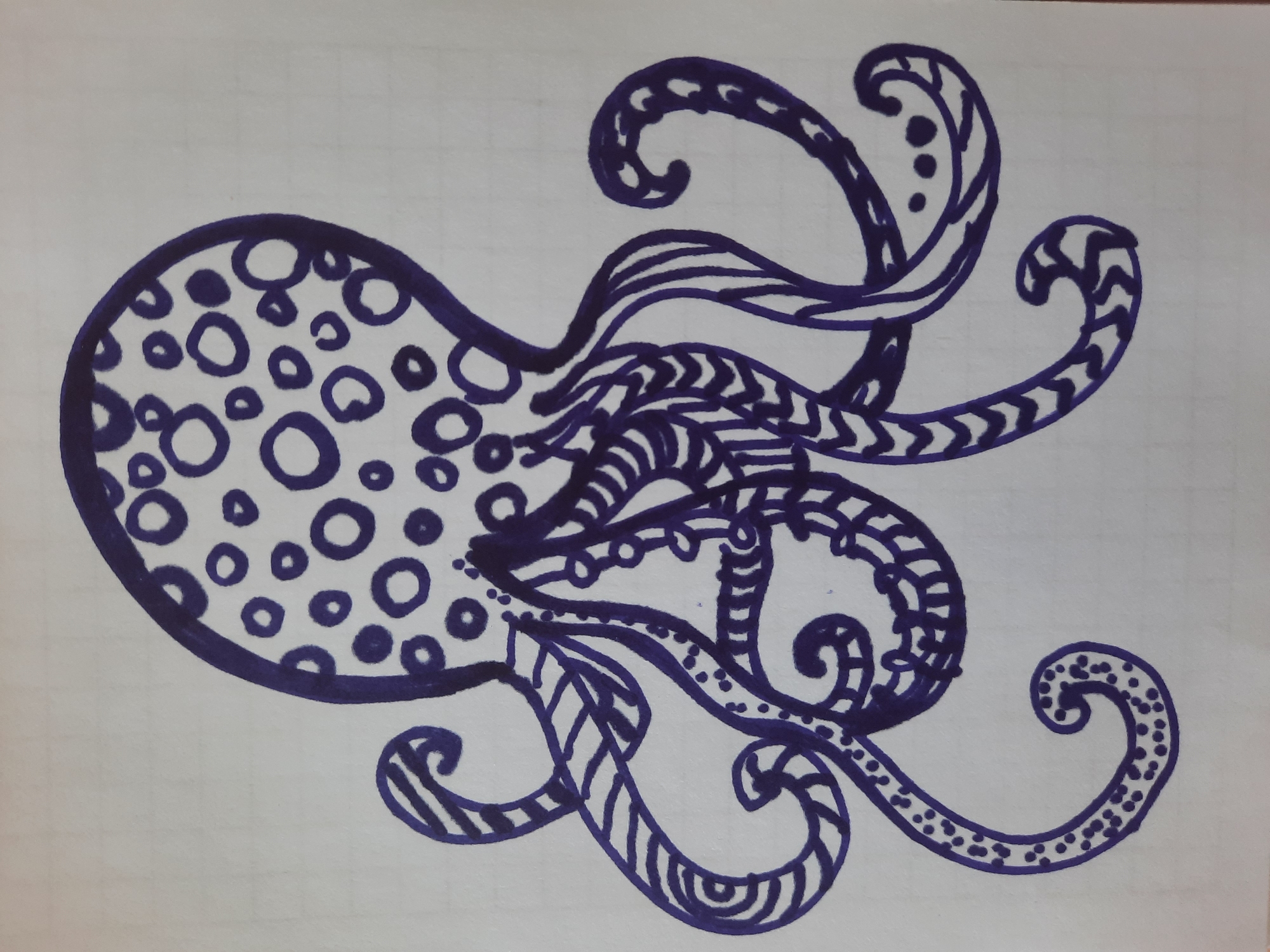An ink drawing of an octopus on graph paper features the creature's body decorated with numerous circles of varying sizes. Its tentacles are adorned with intricate patterns including stripes, zigzags, dots, and swirls. The drawing is situated on a white background with a faint grid pattern visible. There is no indication of Simferopol, Ukraine, or any specific location within it.