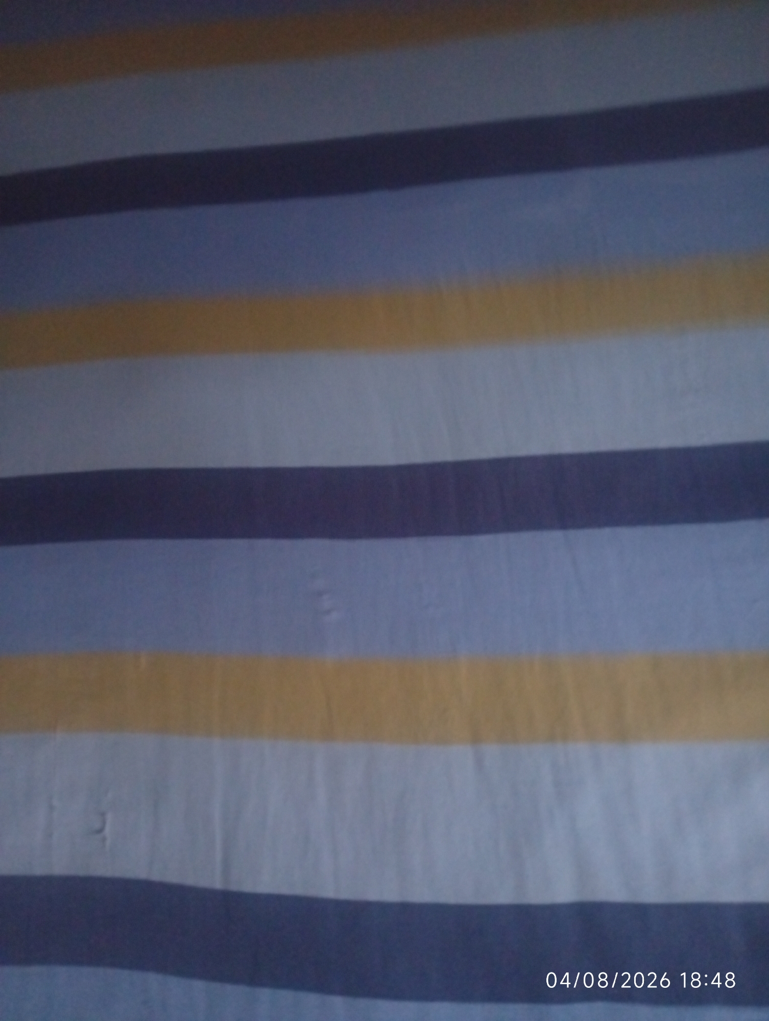 The image shows a striped fabric with horizontal bands of dark blue, light blue, and yellow. The fabric appears to be slightly wrinkled. A timestamp in the lower right corner reads "04/08/2026 18:48". There is no discernible information about the city of Rafin Kwara, Nigeria in the image.