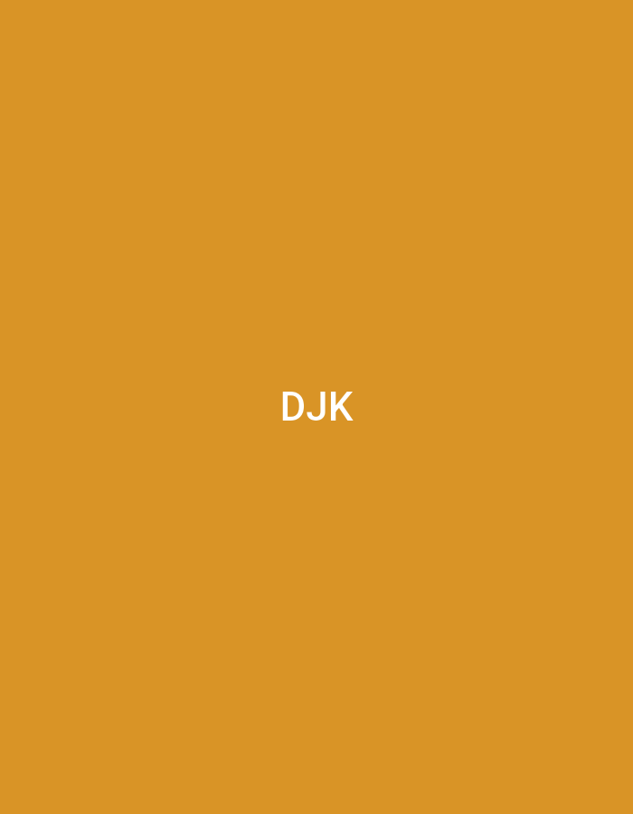 The image displays a plain, solid orange-brown background. Centered horizontally and vertically on this background are the uppercase white letters "DJK" in a sans-serif typeface. There are no people, subjects, objects other than the text and background color, actions, or interactions depicted. The environment is entirely abstract, consisting solely of a flat color field and superimposed text. No identifiable real-world location, including any specific area within Casablanca, Morocco, can be determined from the content of this image.