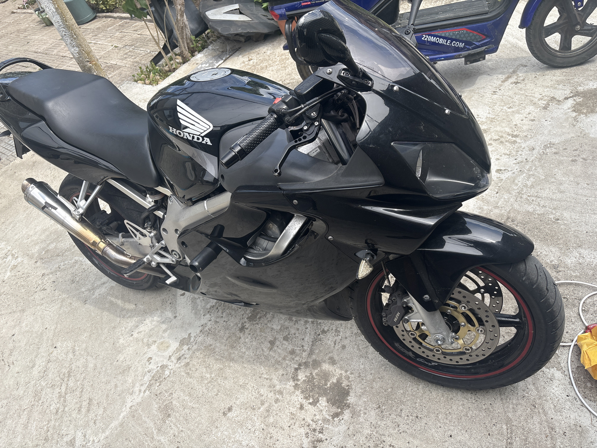 The image depicts a black Honda motorcycle parked on a concrete surface, possibly outdoors. The motorcycle is in good condition. The location is unknown, and there is no indication of it being in Kukorevo, Bulgaria.