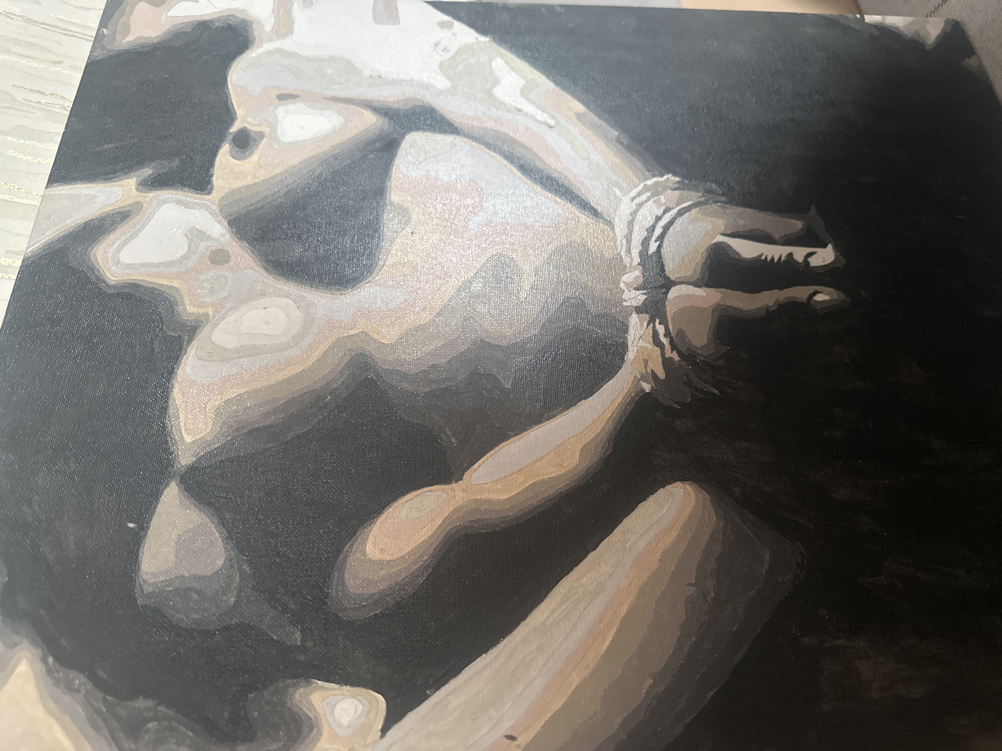 The image shows a painting of a nude figure with their hands bound. The figure is depicted in grayscale with distinct layers of shading. The background is dark, and the subject appears to be positioned in a confined space. The binding on the hands is visible with fine details. The location "Высокий, Russia" does not appear to be related to the image content.
