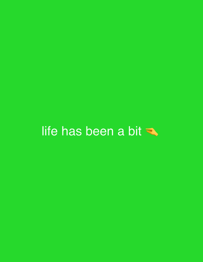 The image displays a bright green background with white text that reads "life has been a bit" and an emoji of a pointing finger. The text is centered horizontally and positioned towards the bottom of the frame. The scene is minimalistic, focusing solely on the text and emoji against the solid colored backdrop. There are no discernible elements of the city of Востец Снт, Russia present in the image.