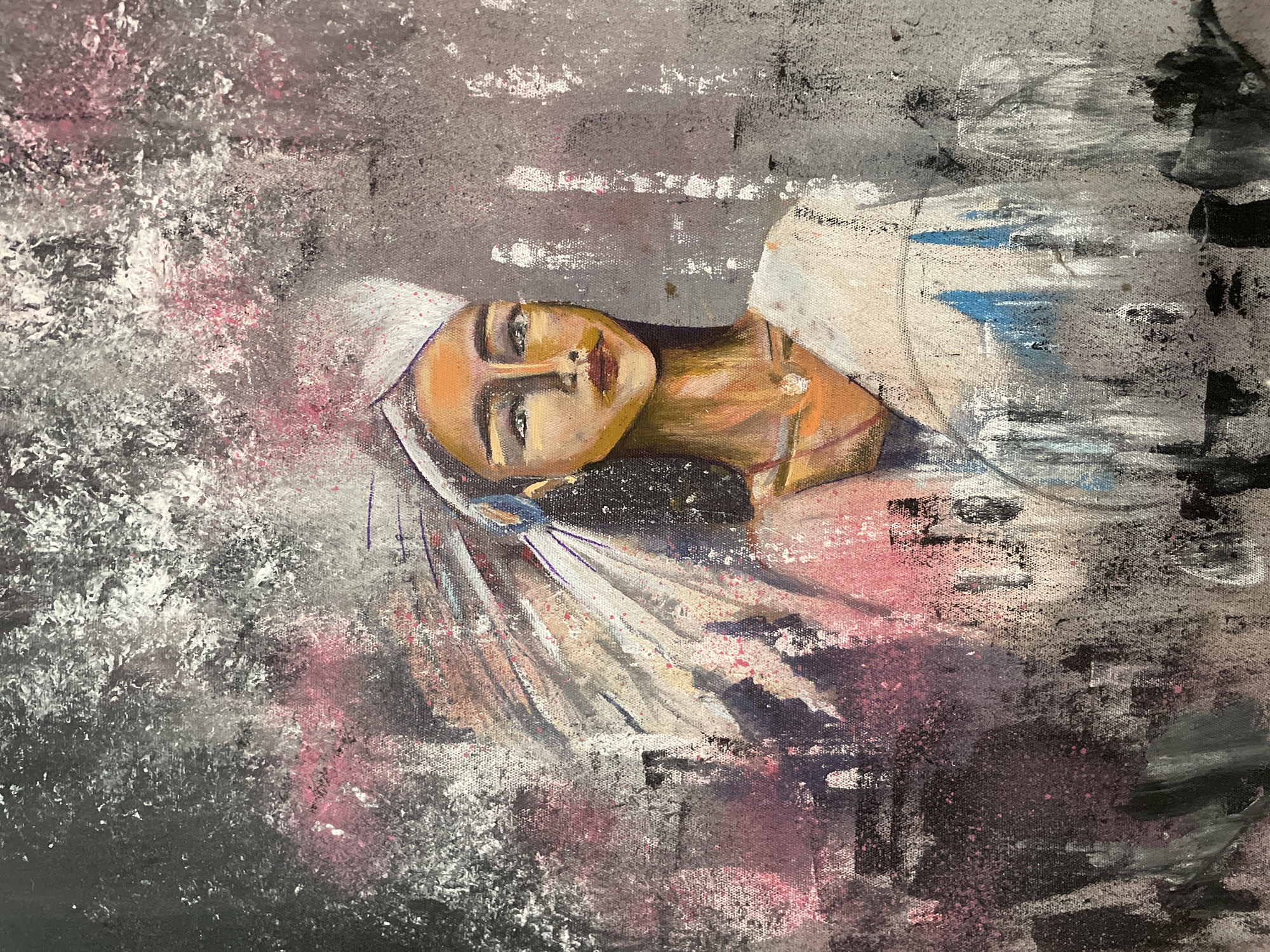 A painting of a woman is depicted. She has an orange skin tone and wears a white head covering. The background is a mix of gray, white, black, and hints of pink. The setting is not evident from the image to determine the location as Ubud District, Indonesia.