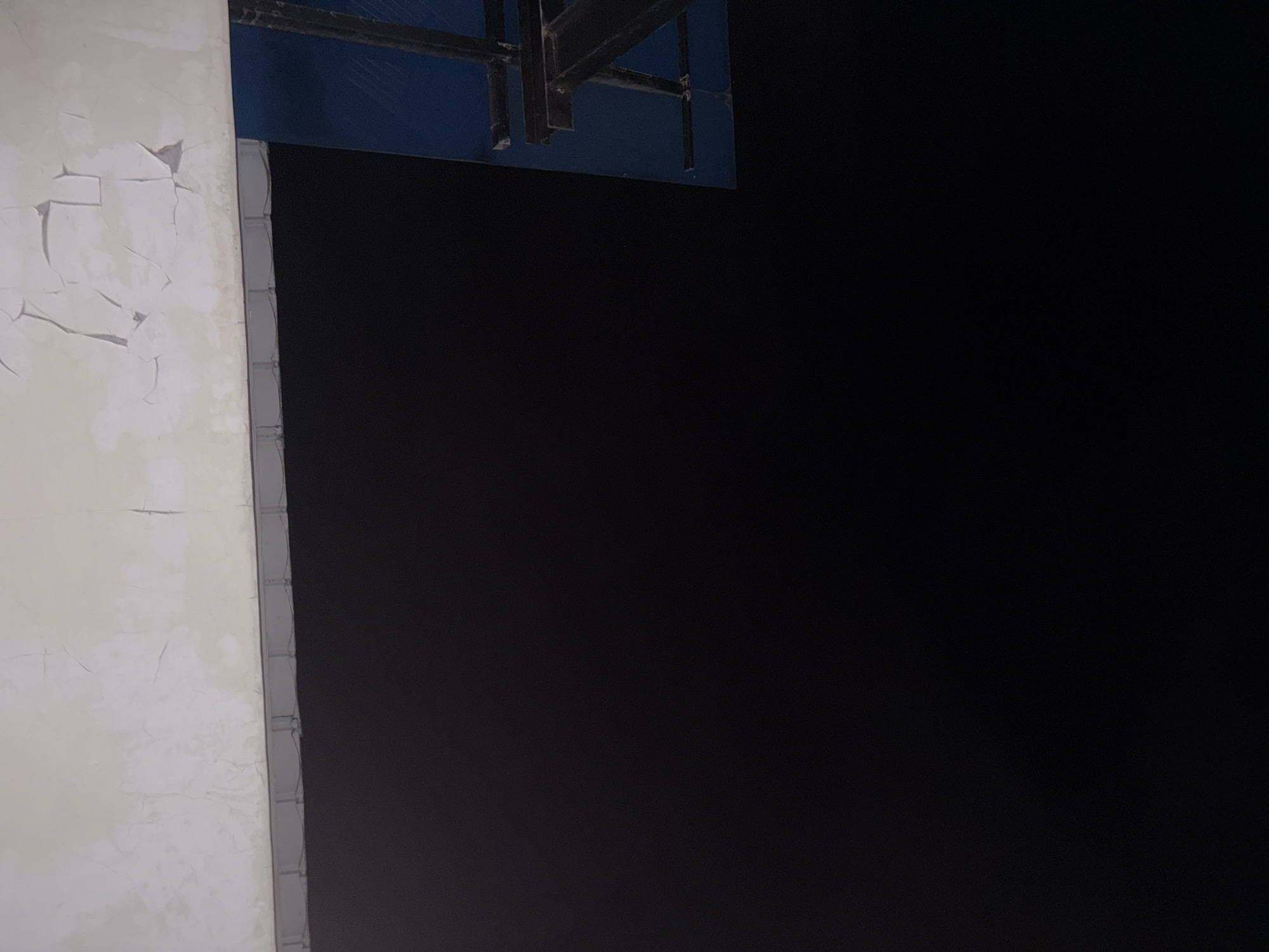 A dark, blurry image with a white, cracked ceiling at the top. A dark grey metallic structure with a blue surface is visible on the right side of the image. The image is an indoor shot, with no visible people. The context of the image and its location in Gempol, Indonesia, are not discernible from the visual information provided.