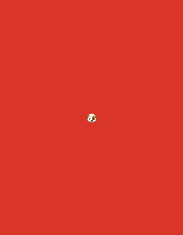 The image is a close-up shot of a red background. Centered in the middle of the frame is a small emoji of a dog's face. The dog emoji has white fur with brown patches around its eyes and ears, and it has black eyes and a pink nose. The background is a uniform, bright red color. There is no discernible location in the city of City of Binjai, Indonesia.