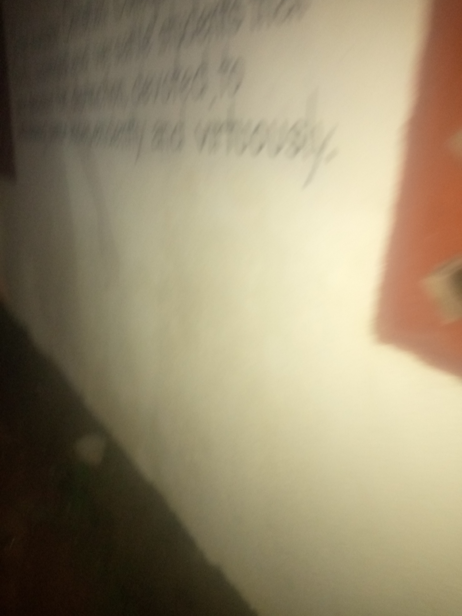 The image shows a close-up of text written on a light-colored surface, possibly paper or a wall. The text is in a cursive script and is somewhat blurry, making it difficult to read definitively. The overall lighting suggests an indoor environment. Due to the lack of contextual visual cues, it is not possible to determine the specific location within the city of Jalingo, Nigeria, or to describe any people, subjects, objects, actions, interactions, or environmental details beyond the presence of handwritten text.