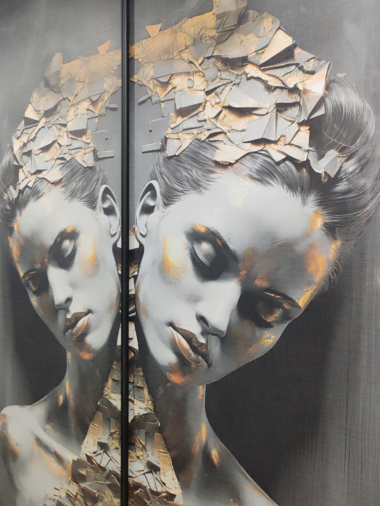 The image shows a close-up of two panels, likely sliding doors or large framed artworks, depicting a woman with a fractured, metallic-looking headpiece and body adornment. The woman has a serene expression, with eyes closed and head tilted. The color palette is primarily grayscale with gold accents. The location is Kudrovo, Russia.