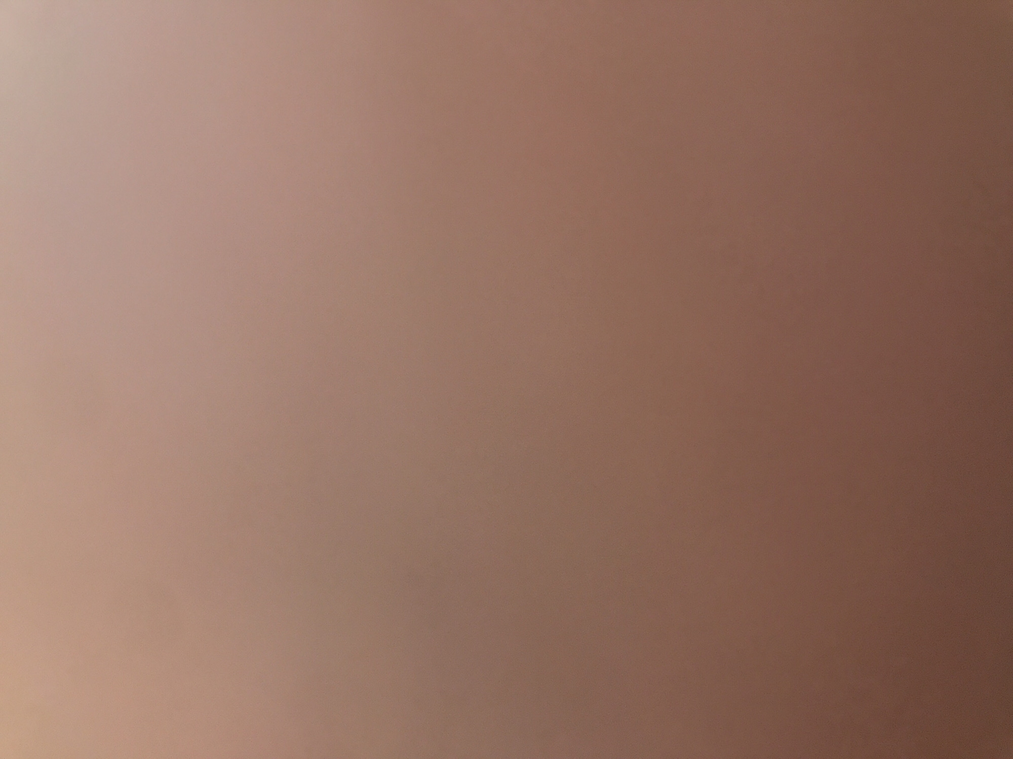 The image shows a blurred, uniform brown surface with subtle variations in tone, suggestive of soft, diffused lighting. There are no identifiable objects, people, or indicators of a location, including Yerevan, Armenia.