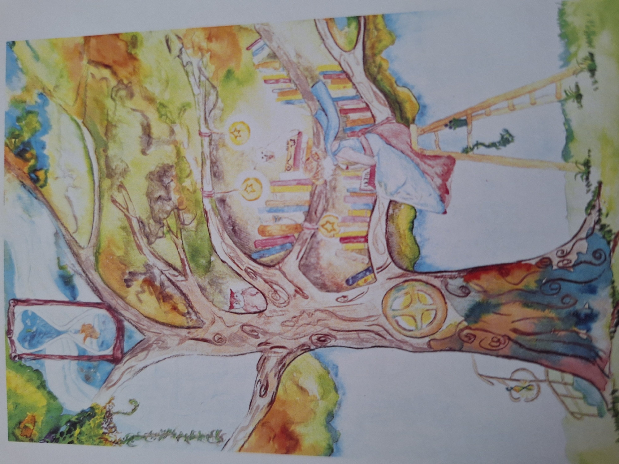 The image depicts a watercolor painting of a fantastical tree. The tree's trunk is wide and gnarled, with colorful, abstract patterns painted on its bark. Carved into the trunk are circular openings, some with geometric designs. Branches of the tree extend upwards and outwards, supporting a multitude of books arranged as if they were growing from the wood. Small, whimsical details are scattered throughout the tree, including an hourglass with a goldfish inside at the top, an owl peeking out from a hole, and star-shaped lanterns hanging from the branches. A ladder leans against the tree, and a woman in a flowing blue and pink dress is seated on a stool near the ladder, reading a book. The environment surrounding the tree is a lush, green landscape with patches of colorful foliage. There are no identifiable landmarks or indications of a specific city or country within the painting itself, therefore it is not possible to determine if this scene is located in Varna, Bulgaria or any other specific location.