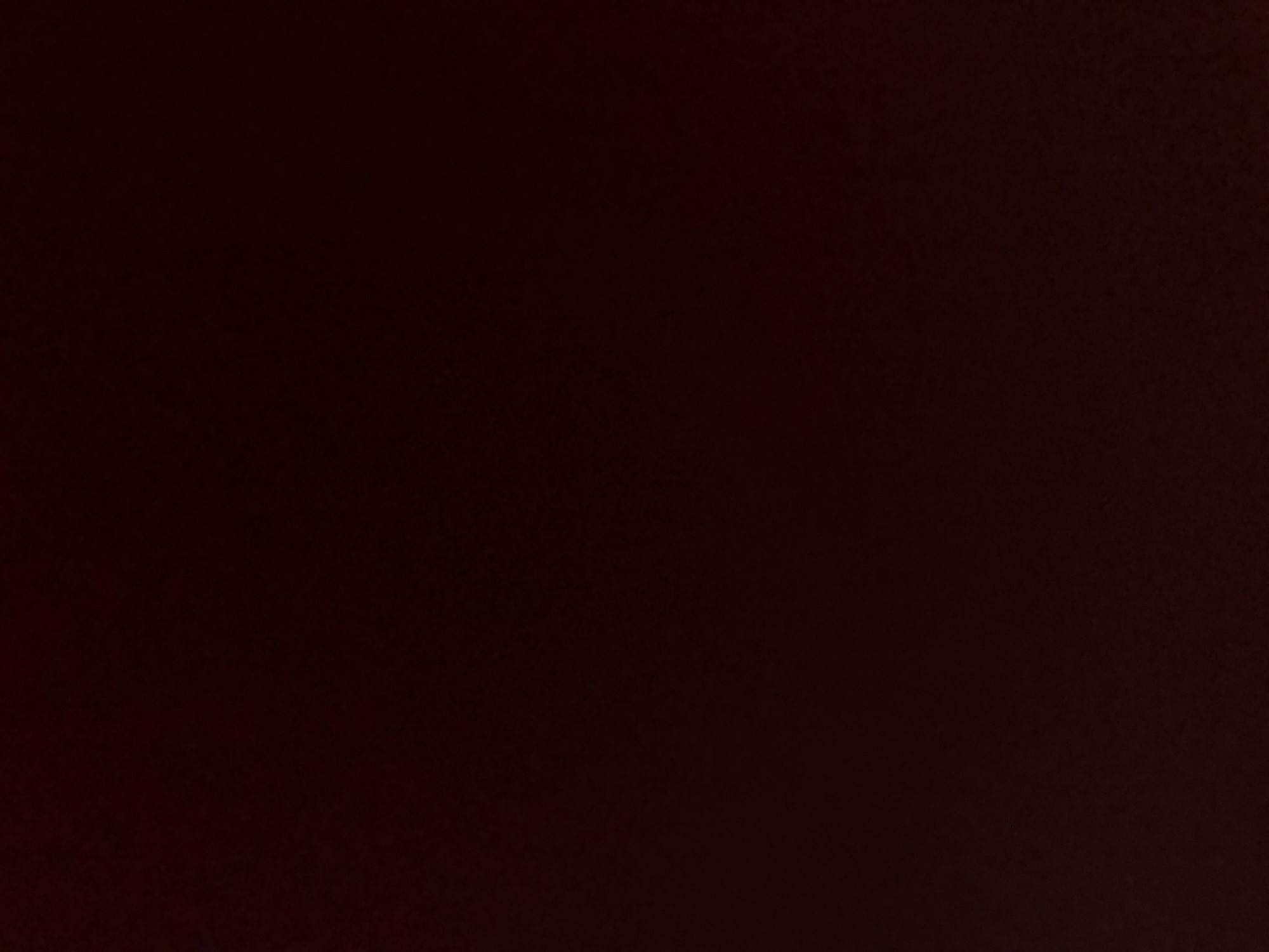 The image is a dark, indistinct photograph with very low light levels. It is impossible to determine a specific location in Yerevan, Armenia, or any other details about people, subjects, objects, actions, interactions, or the environment. The image essentially depicts a black or near-black surface.