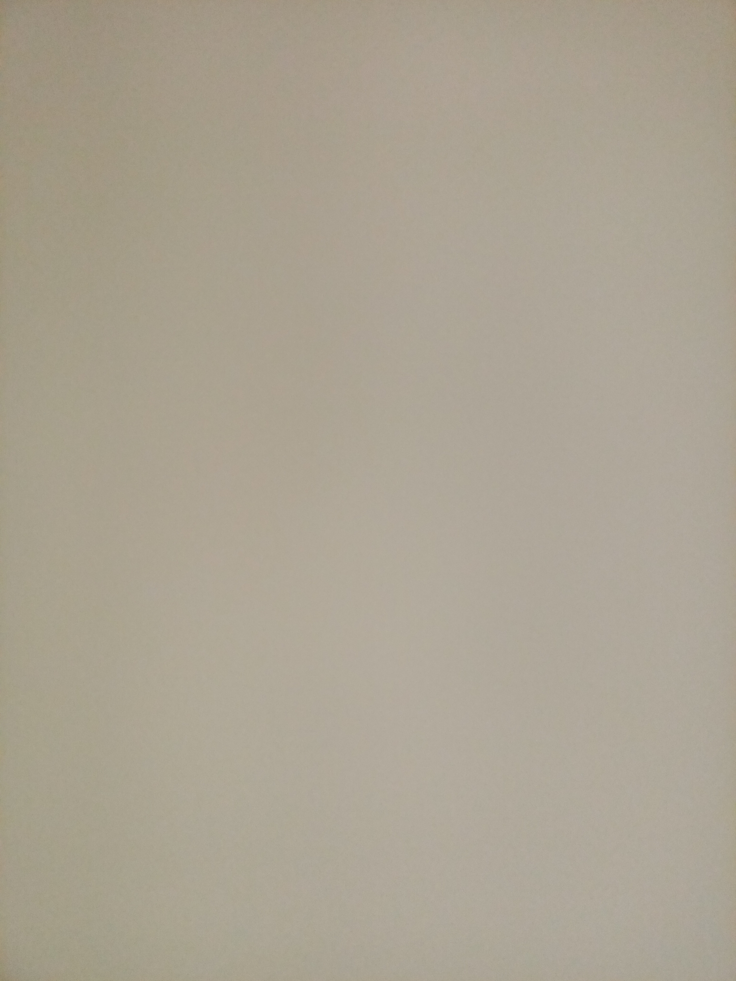 The image is a close-up, full-frame shot of a textured, beige-colored surface, likely a wall or paper. The lighting is even, with no discernible shadows or highlights to suggest a specific direction of light. There are no objects, people, or any distinguishing features visible in the image, rendering it a blank canvas. The location in Rostov-on-Don, Russia, is not discernible from the image content itself.
