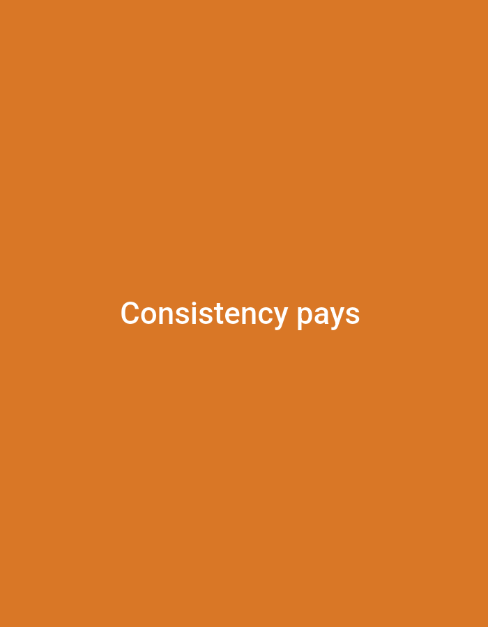 The image is a plain orange background with white text that reads "Consistency pays" centered on the screen. The text is in a sans-serif font and appears to be in all lowercase, except for the initial "C" and "p" which are capitalized. There are no other objects or people visible in the image. The location in Jalingo, Nigeria is not discernible from the image itself.