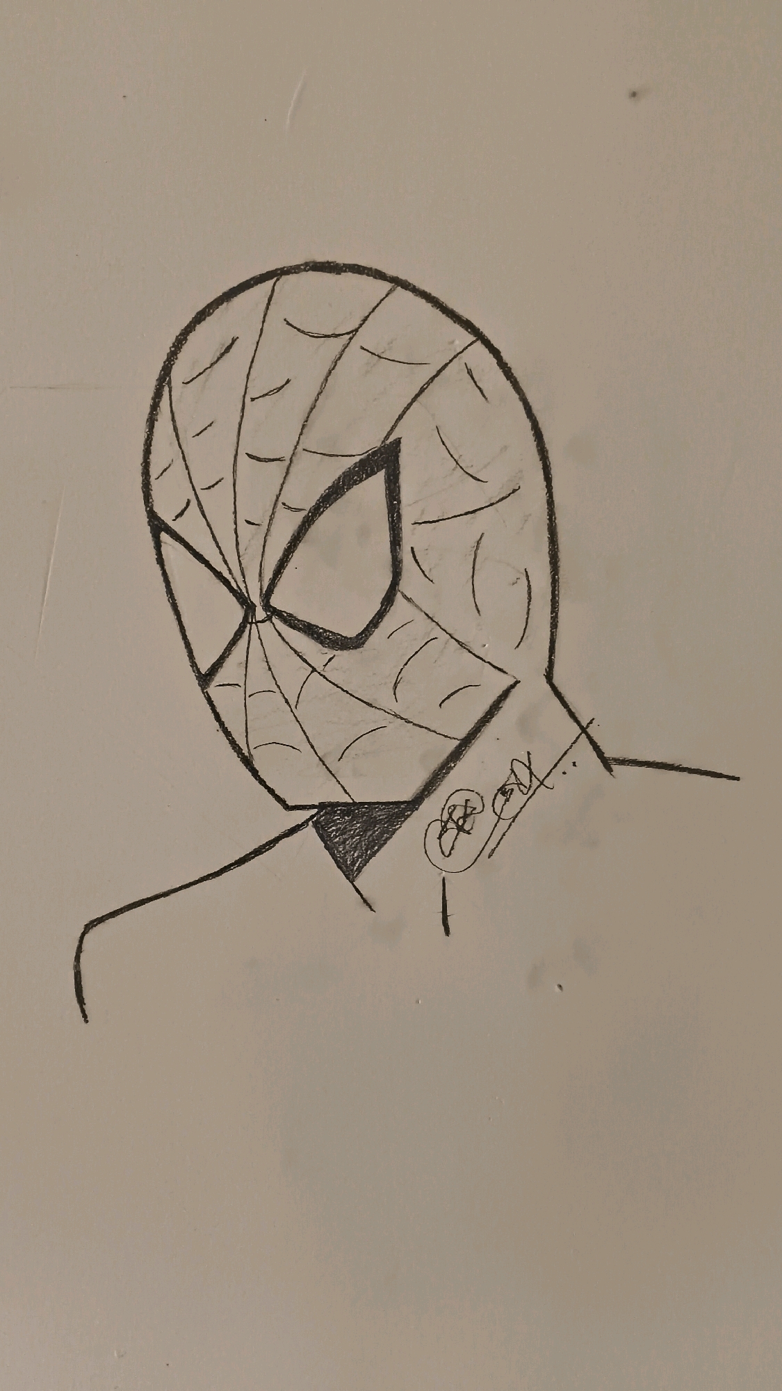 A pencil sketch of Spider-Man's masked face is depicted on a textured, light-colored surface. The mask is a classic design with black outlines and segmented white areas representing the eyes, connected by a web pattern. Shading is used to create depth and dimension. On the right side of the neck area of the mask, a stylized signature or doodle is present. The sketch appears to be rendered on paper, with a slightly grainy texture visible. The image is cropped to focus on the upper portion of the character's head and shoulders. There is no discernible city or environmental context, including Sarafpalle, India, present in the image itself.