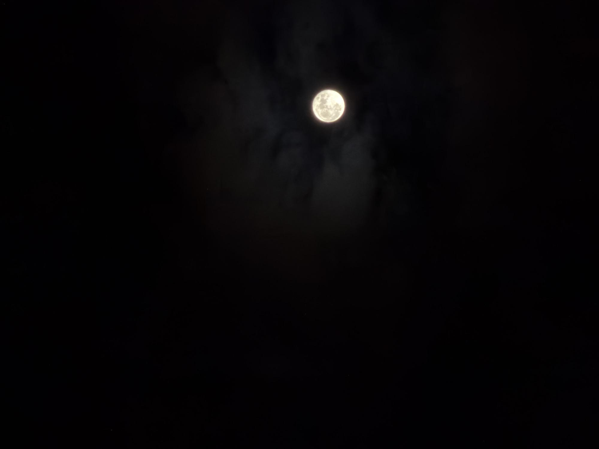 The image shows a full moon in a dark night sky. There are some faint clouds near the moon. The exact location of the image in Batumi, Georgia is not discernible from this image.