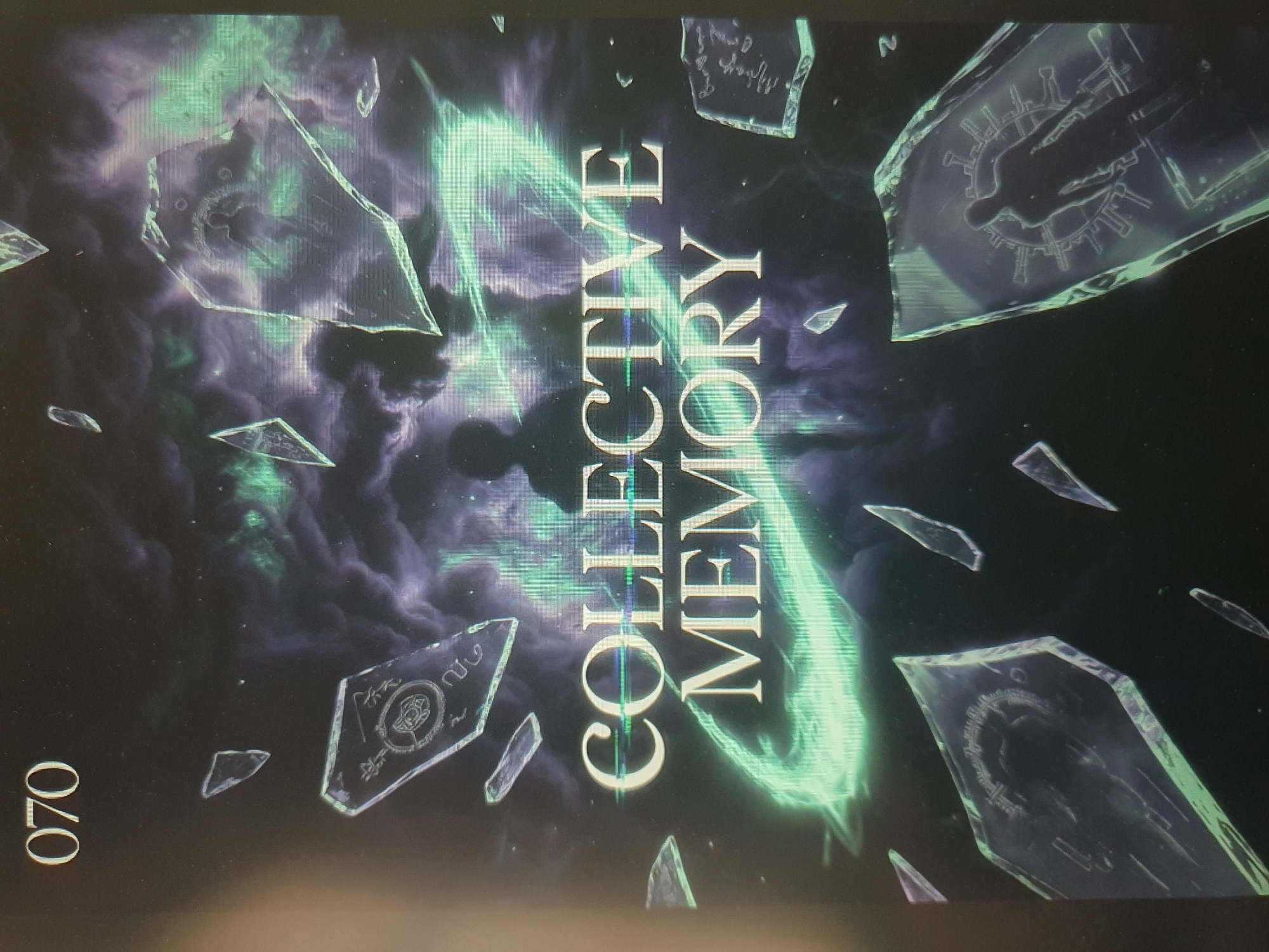This media file appears to be the cover of a book or magazine titled "COLLECTIVE MEMORY". The artwork depicts a surreal, cosmic scene with fragmented, crystalline shards scattered across a nebula-like background of dark purples and vibrant green swirls.
Within these shards, silhouettes of human figures are visible, some with circular, star-like patterns around them. One prominent shard shows a silhouette of a person within a ring of what resembles a stylized corona or radiating energy. Another shard contains what looks like ancient or mystical symbols.
A bright, glowing green energy vortex or ring is a central element, appearing to emanate from or surround the text "COLLECTIVE MEMORY", which is vertically oriented and rendered in large, serif font.
The overall mood is mysterious, ethereal, and perhaps a bit unsettling, evoking themes of fragmented memories, cosmic connections, or spiritual exploration. The fragments of glass or crystal suggest brokenness and reflection, while the nebulae suggest the vastness of space or consciousness.
There are two pieces of visible text. The title "COLLECTIVE MEMORY" is prominently displayed. In the lower left corner, the number "070" is visible.
The location context provided is Tashkent, Uzbekistan. This information does not appear to be directly depicted in the visual elements of the cover itself. There are no clear indicators of time of day or weather.