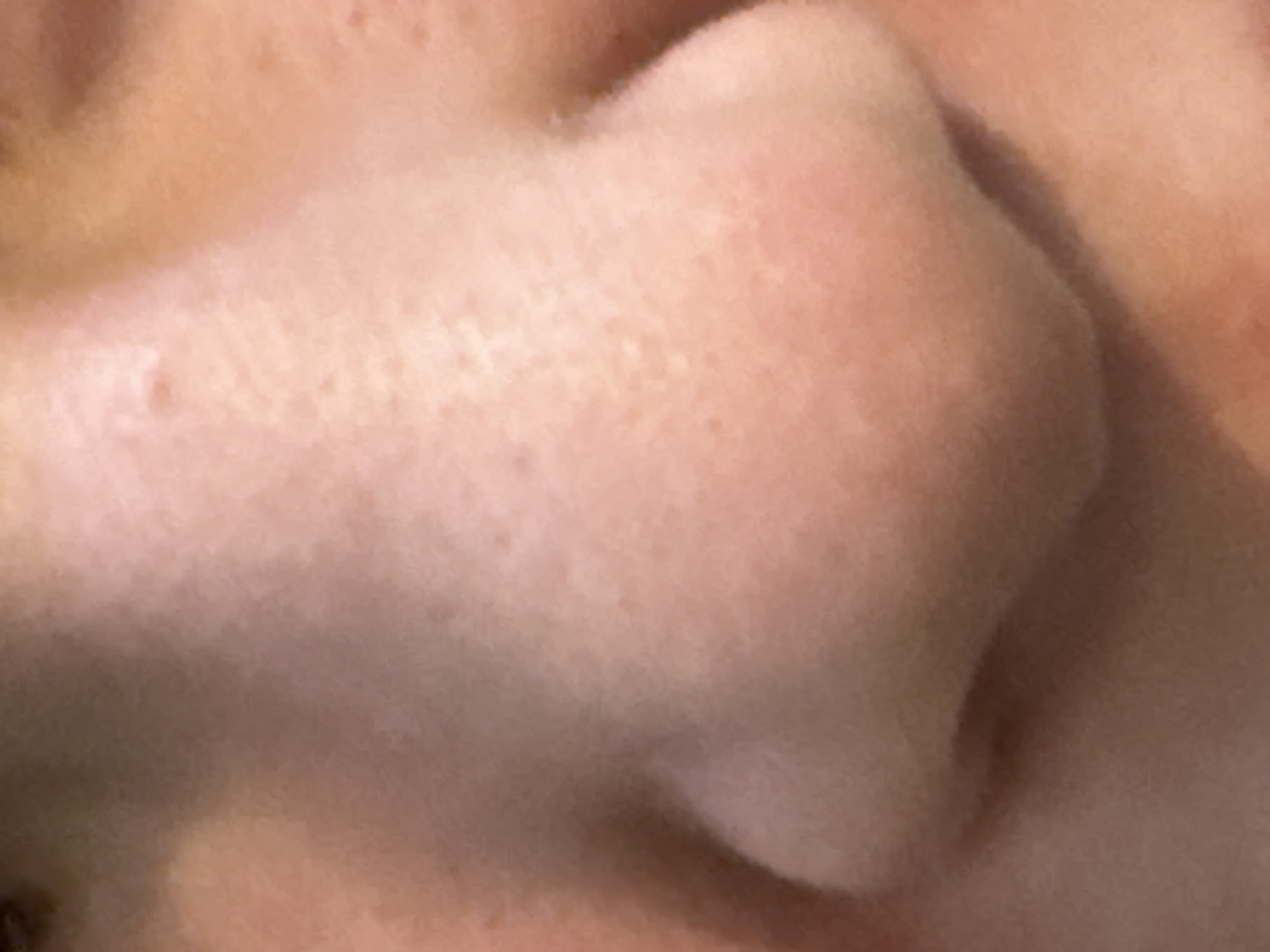 The image is a close-up, slightly blurry, and overexposed photograph of a human nose. The skin tone is light with visible pores and some minor blemishes or freckles. The lighting casts a soft shadow along the side of the nose, highlighting its contours. The background is out of focus and appears to be more skin, suggesting a selfie or a tightly framed portrait. There are no other objects or discernible environmental features visible in the image. The location of the image in the city of Omsk, Russia, cannot be determined from the visual information provided.