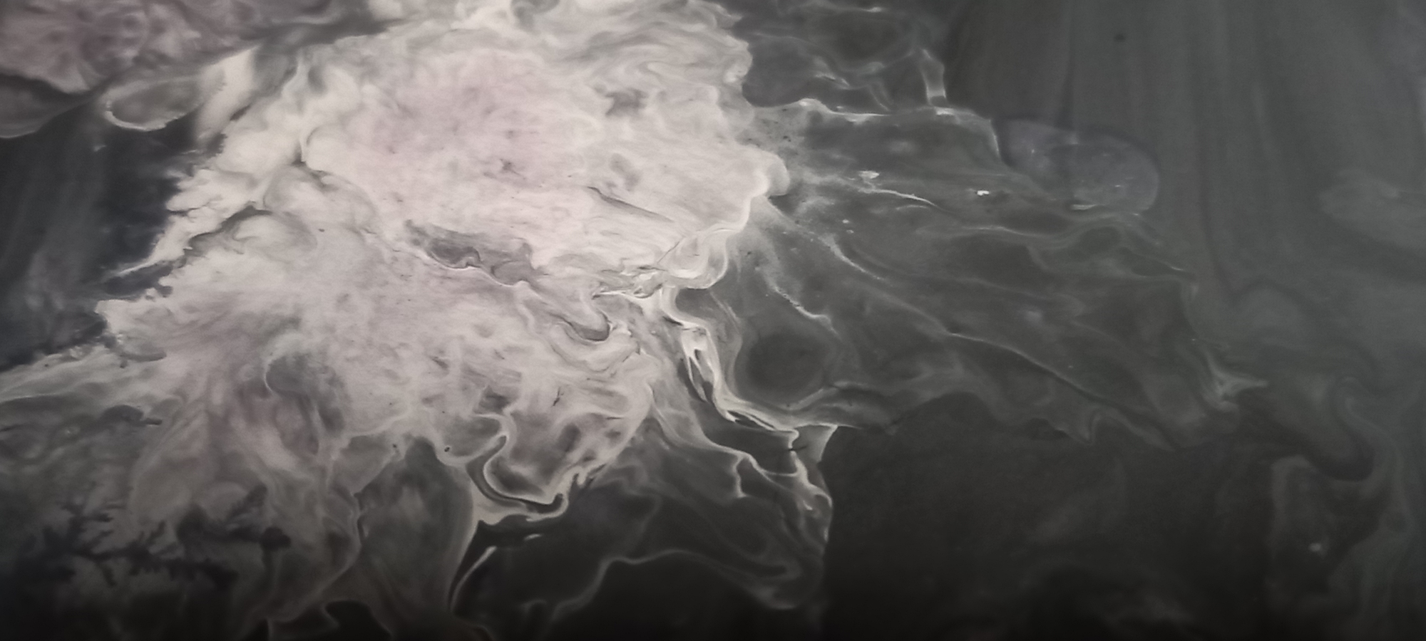 This is an abstract image of swirling gray and white paint or ink, with no discernible subjects, objects, actions, or interactions. The image does not depict any location in the city of Kryvyi Rih, Ukraine.