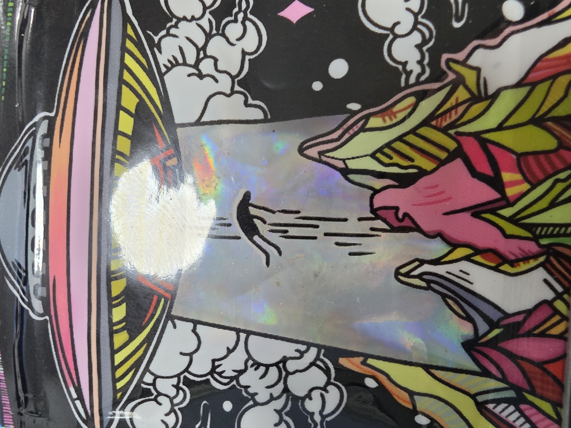 This vibrant, colorful image depicts a stylized alien abduction scene. On the left, a large, grey and black UFO with colorful segments (pink, orange, yellow) along its rim emits a powerful, bright beam of light from its underside. This beam, which occupies the central portion of the image, has a shimmering, holographic effect, reflecting rainbow colors.
Within this luminous beam, a dark, silhouetted human-like figure is being pulled upwards, depicted with trailing lines suggesting rapid movement towards the UFO. The figure appears to be in a dynamic, perhaps struggling or soaring, posture.
To the right of the beam, an abstract and vividly colored landscape or mass is rendered with thick black outlines. This features sharp, angular forms in shades of green, yellow, pink, and red, resembling stylized mountains, foliage, or a fantastical alien environment. Scattered throughout the black background, particularly around the UFO and above the abstract landscape, are white, cartoon-like clouds outlined in black. Small white dots and a single pink diamond shape are also visible in the dark sky.
The overall style is reminiscent of comic book art or graphic design, characterized by bold outlines and a flat, yet intensely colored, palette. There is no visible text in the image.
