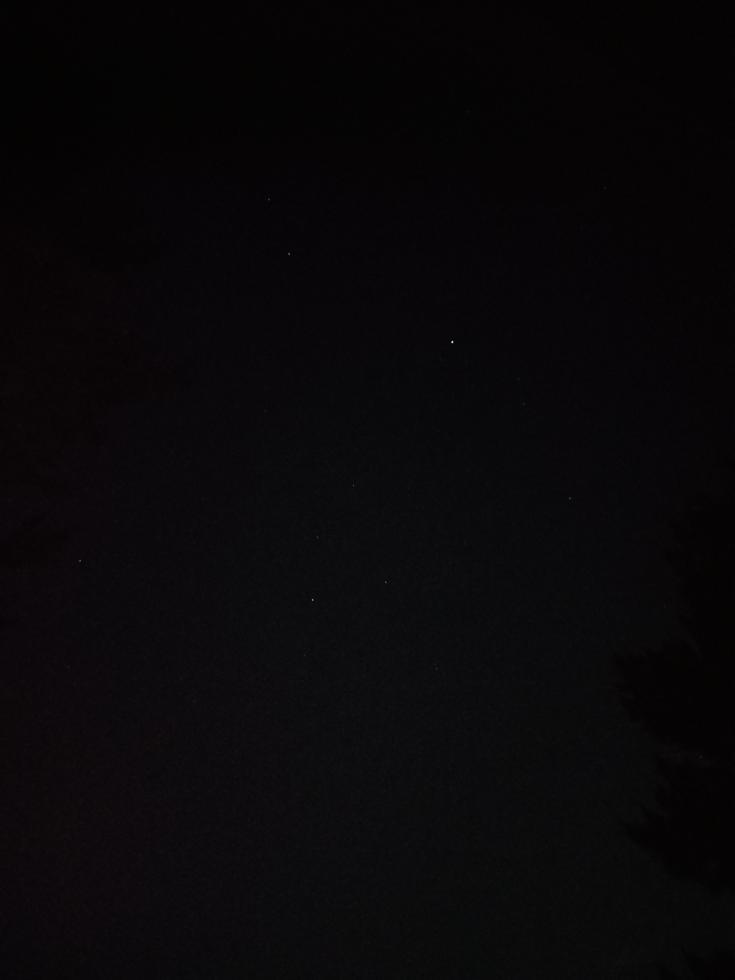 This media file presents a photograph of a clear night sky, set in Sofia, Bulgaria. The primary subjects are numerous small, bright points of light, identifiable as stars, scattered across a predominantly dark, black background. The image depicts an expansive view of the cosmos during nighttime.
In the original image, subtle, indistinct dark shapes are barely visible along the bottom edge, particularly in the lower right corner, suggesting the tops of trees or other natural landscape elements silhouetted against the dark sky. These foreground details are very faint, emphasizing the vastness and depth of the celestial scene above.
The provided crops offer closer inspections of various sections of the night sky, highlighting the distribution and varying brightness of the stars. Some crops show brighter, more prominent stars, while others reveal fainter clusters. The clarity of the visible stars indicates a clear night with good atmospheric conditions, likely with minimal light pollution. No specific activity or event is taking place other than the static presence of the stars in the night sky. There is no visible text in the image. The time of day is definitively night, and the weather is clear.