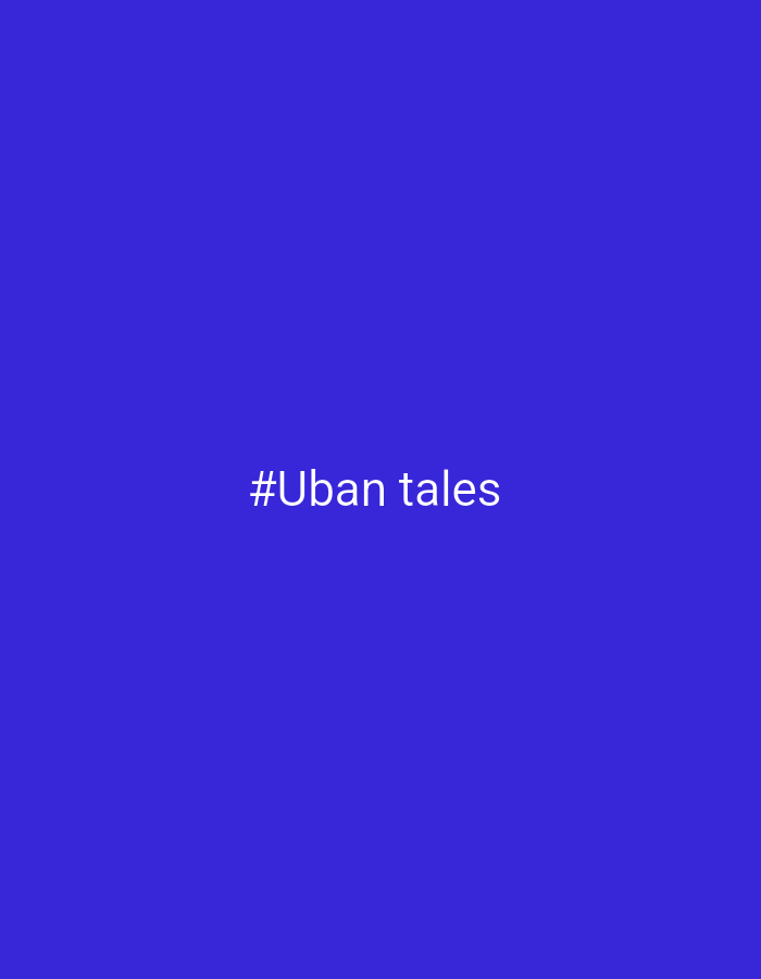 The image is a plain blue background with the white text "#Uban tales" centered in the middle. There are no other details present in the image. The location is not inferable from the image, nor is the identity of any subjects, objects, or interactions.