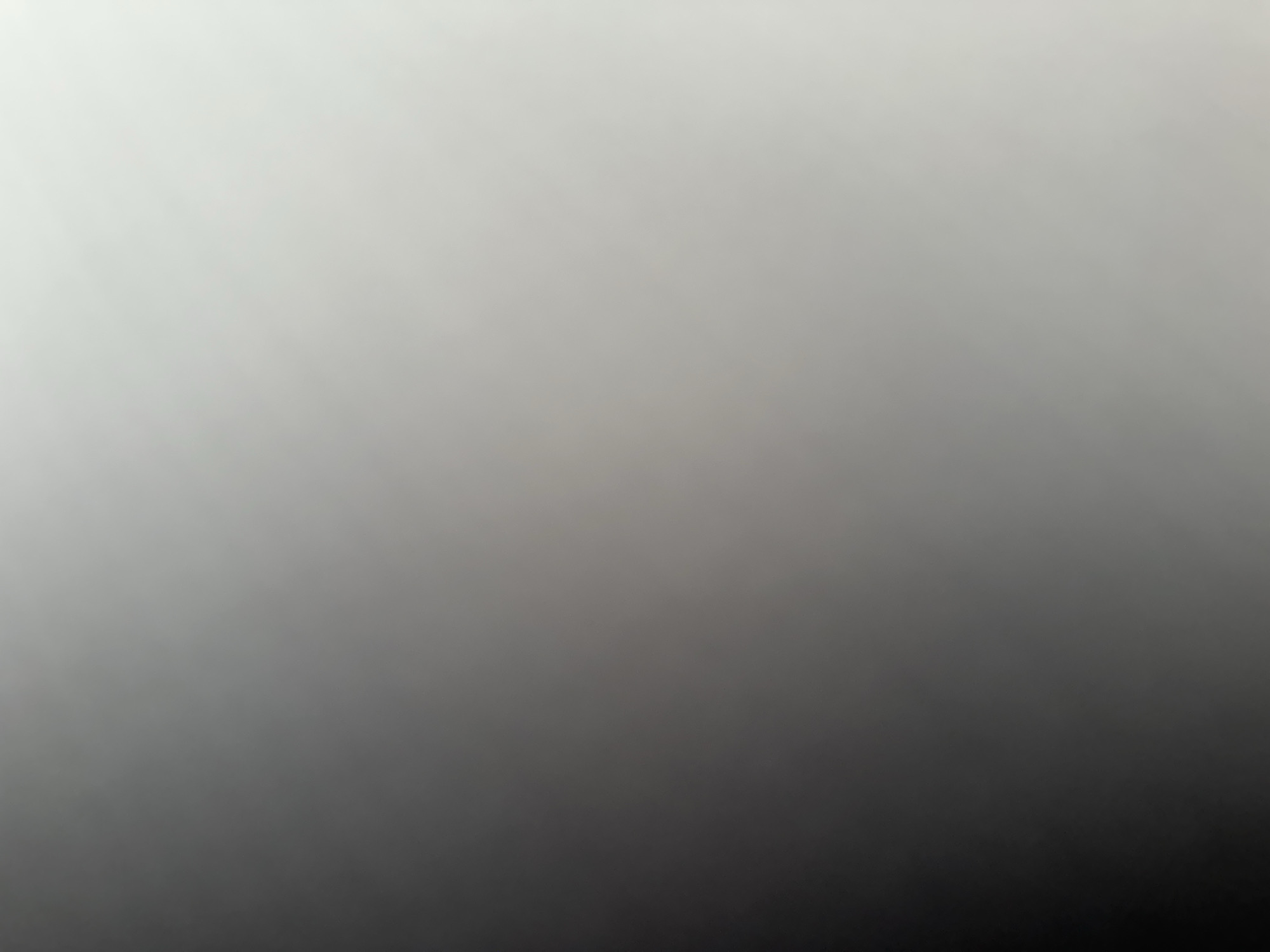 This is a medium shot, full-frame photograph of a gradient that transitions from white on the top left to black on the bottom right. The gradient is smooth and lacks any discernible subjects, objects, scene, setting, or activity. There is no visible text, time of day, weather, location cues, or emotions conveyed. The image appears to be an abstract representation of light and shadow, or a background element.