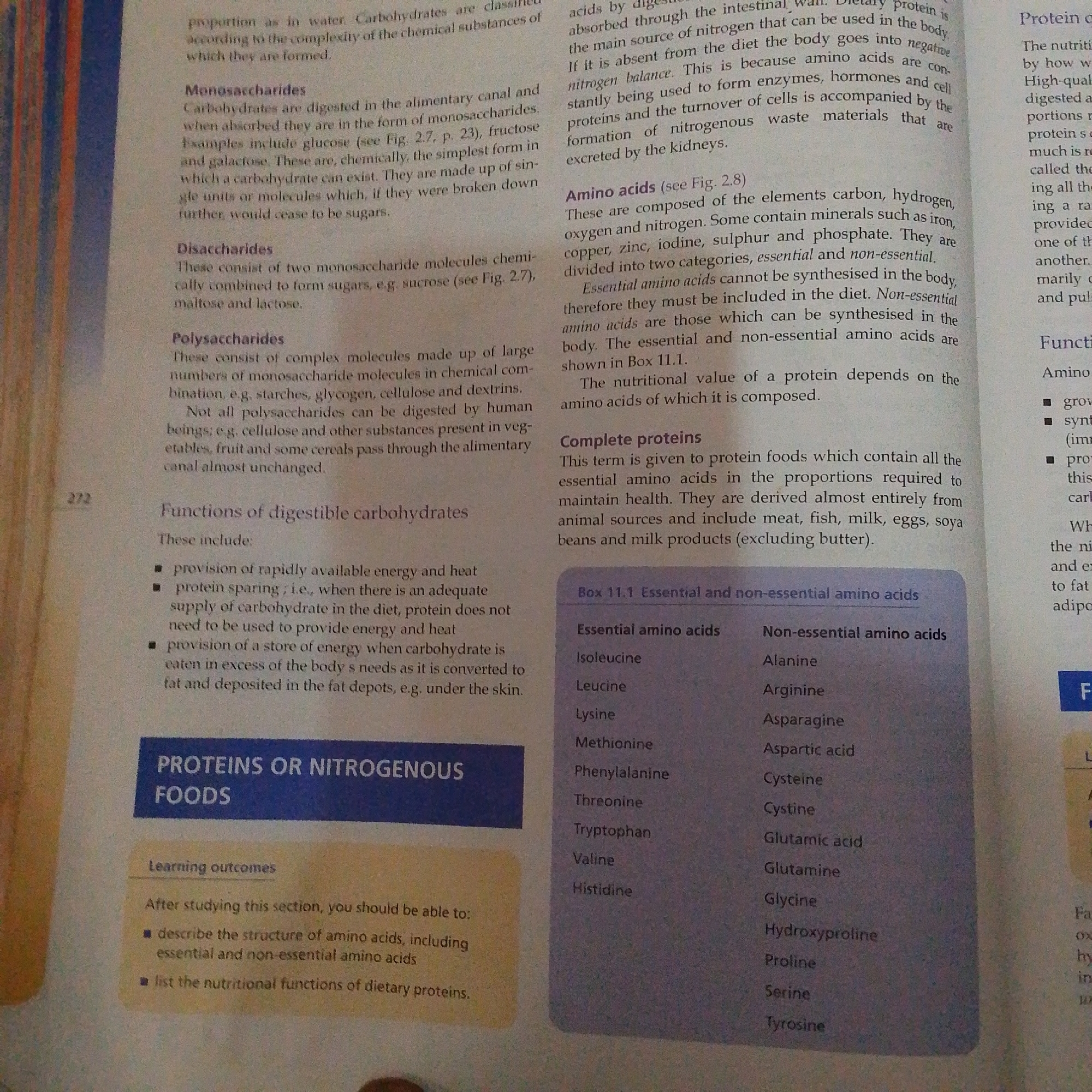 The image provided is a photograph of an open textbook page detailing nutritional science. The left side of the page discusses carbohydrates, specifically monosaccharides, disaccharides, and polysaccharides, followed by the functions of digestible carbohydrates. The right side of the page begins a section on "PROTEINS OR NITROGENOUS FOODS," with information on amino acids, complete proteins, and a box (Box 11.1) listing essential and non-essential amino acids. There are no discernible elements in the image that would indicate a location in Jalingo, Nigeria, nor are there any people, specific objects beyond the book itself, actions, or interactions depicted. The environment is simply a flat surface upon which the book is placed, with some lighting suggesting an indoor setting.