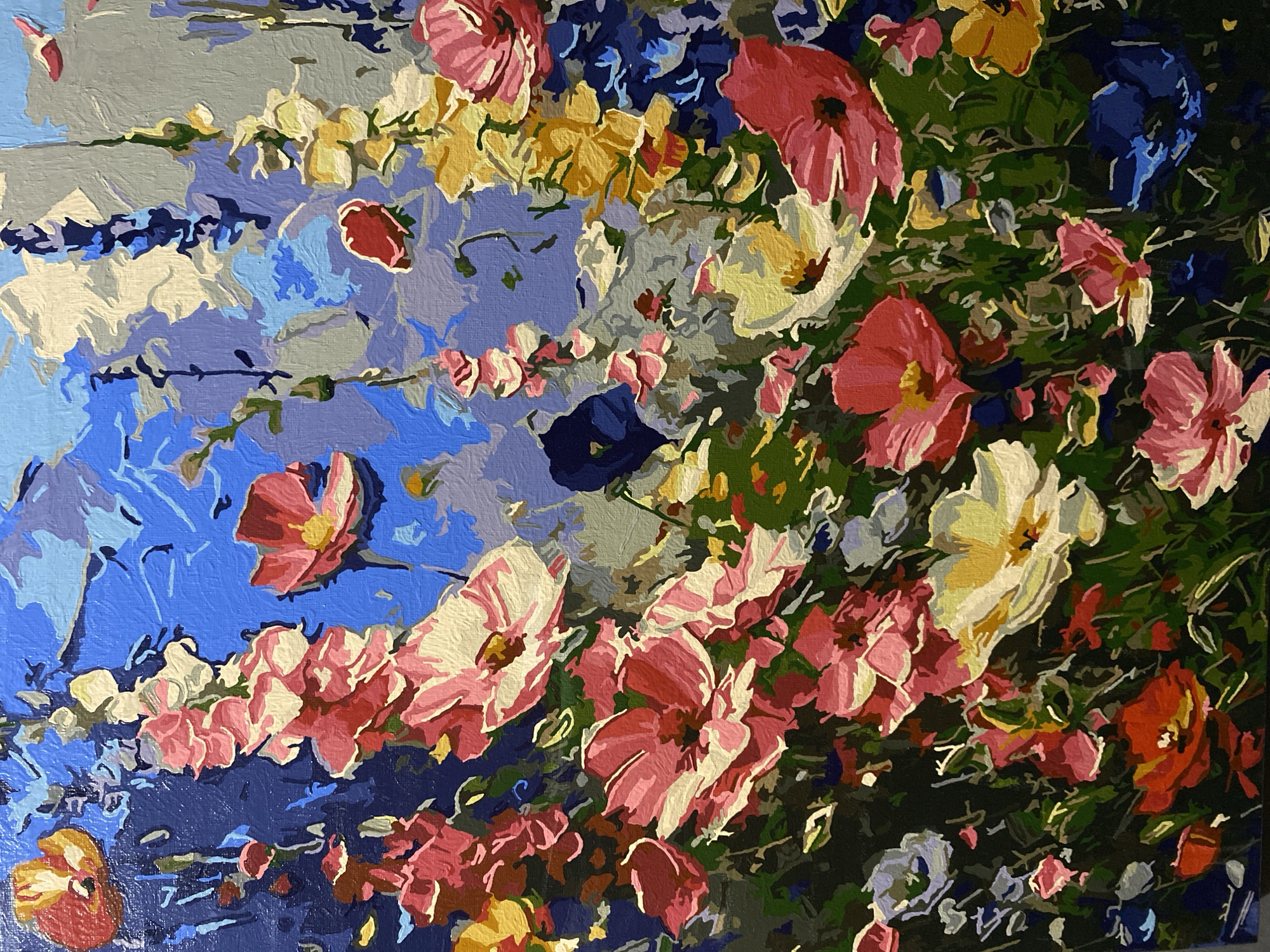 This is a close-up, vertical, eye-level, detailed shot of a colorful, abstract painting of a flower garden. The painting features a dense arrangement of various flowers in shades of pink, red, yellow, and white, with a vibrant blue sky as the background. The brushstrokes are visible, giving the painting a textured and impressionistic quality. There are no people or identifiable landmarks present. The image is of a painting and does not depict any specific location within the city of Tambov, Russia.