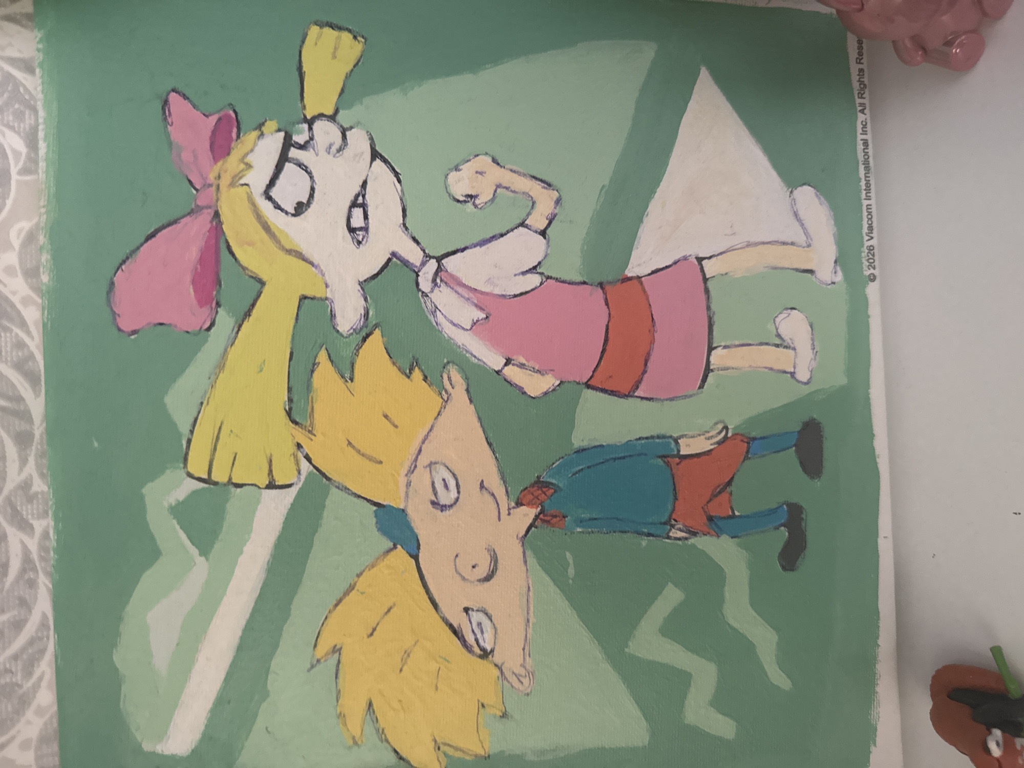 An illustration of two cartoon characters, Arnold and Helga from the show Hey Arnold!, is displayed on a green background. Arnold, on the left, wears a blue shirt, red shorts, and a red bowtie. His face is tilted downwards with his eyes closed and a slight smile. Helga, on the right, wears a pink dress and a large pink bow in her blonde hair. Her expression is angry, with her teeth clenched and a fist raised. The background features abstract, light green and white shapes resembling jagged mountains or lightning bolts. In the lower right corner, a copyright notice reads "© 2026 Viacom International Inc. All Rights Reser". The illustration appears to be painted on canvas or a similar material.