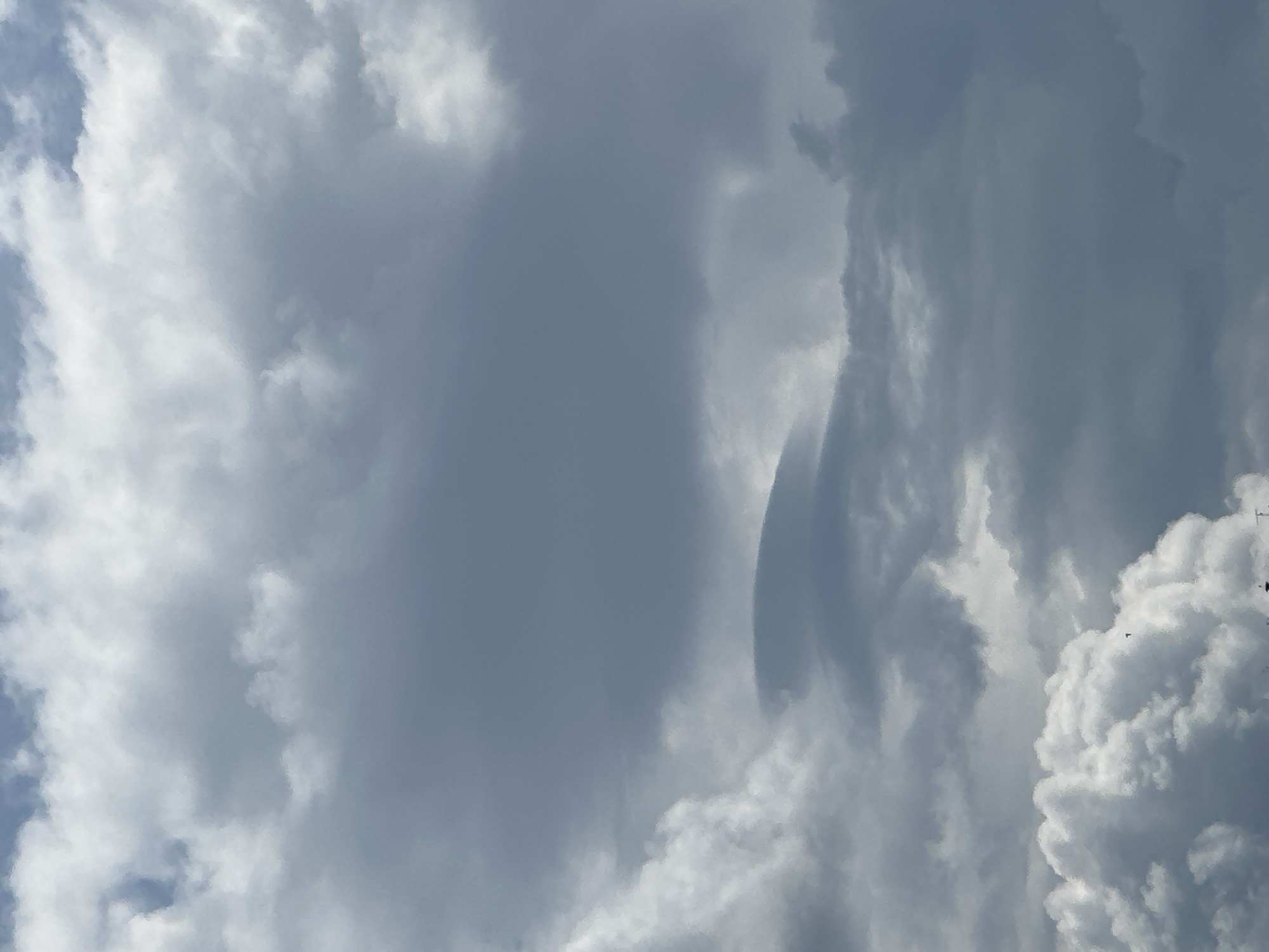 The image shows a cloudy sky. There are no specific details visible that would indicate the location or time. No people, subjects, objects, actions, or interactions are visible. The environment consists solely of clouds and sky.