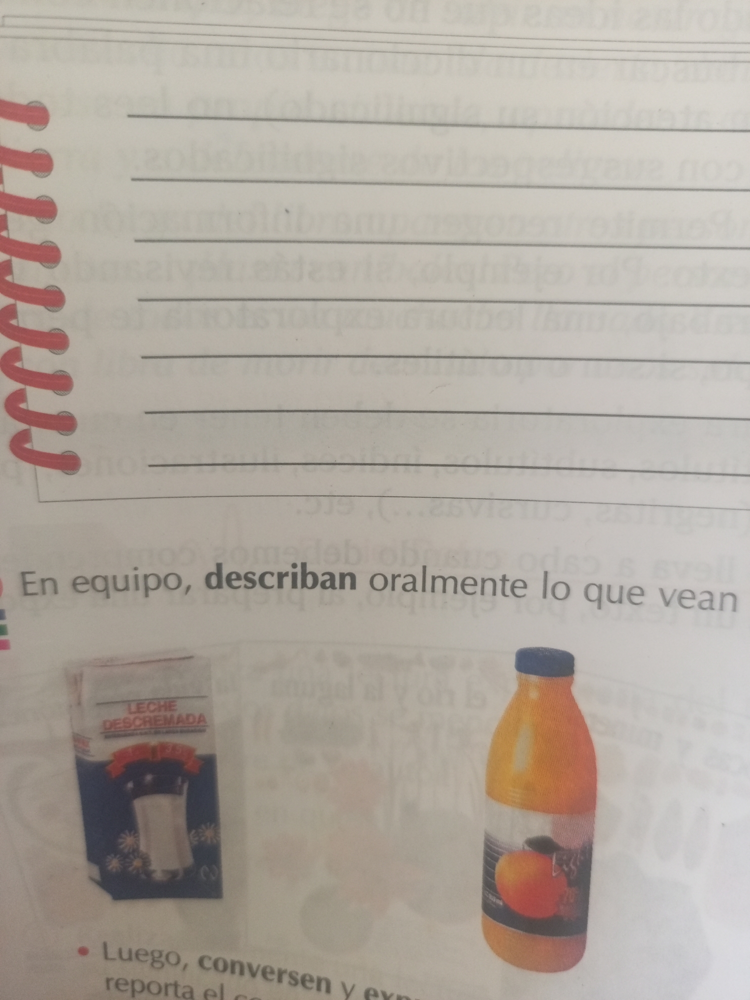 The image shows a page from a notebook with written lines. At the bottom of the page, there are instructions in Spanish that read "En equipo, describan oralmente lo que vean" which translates to "In teams, orally describe what you see." Below the text are two images: one is a carton of "LECHE DESCREMADA" (skimmed milk) with a picture of a shaker and flowers, and the other is a bottle of orange juice with a picture of an orange on the label. The scene does not provide any information about the location being in the city of La Tagua, Venezuela.