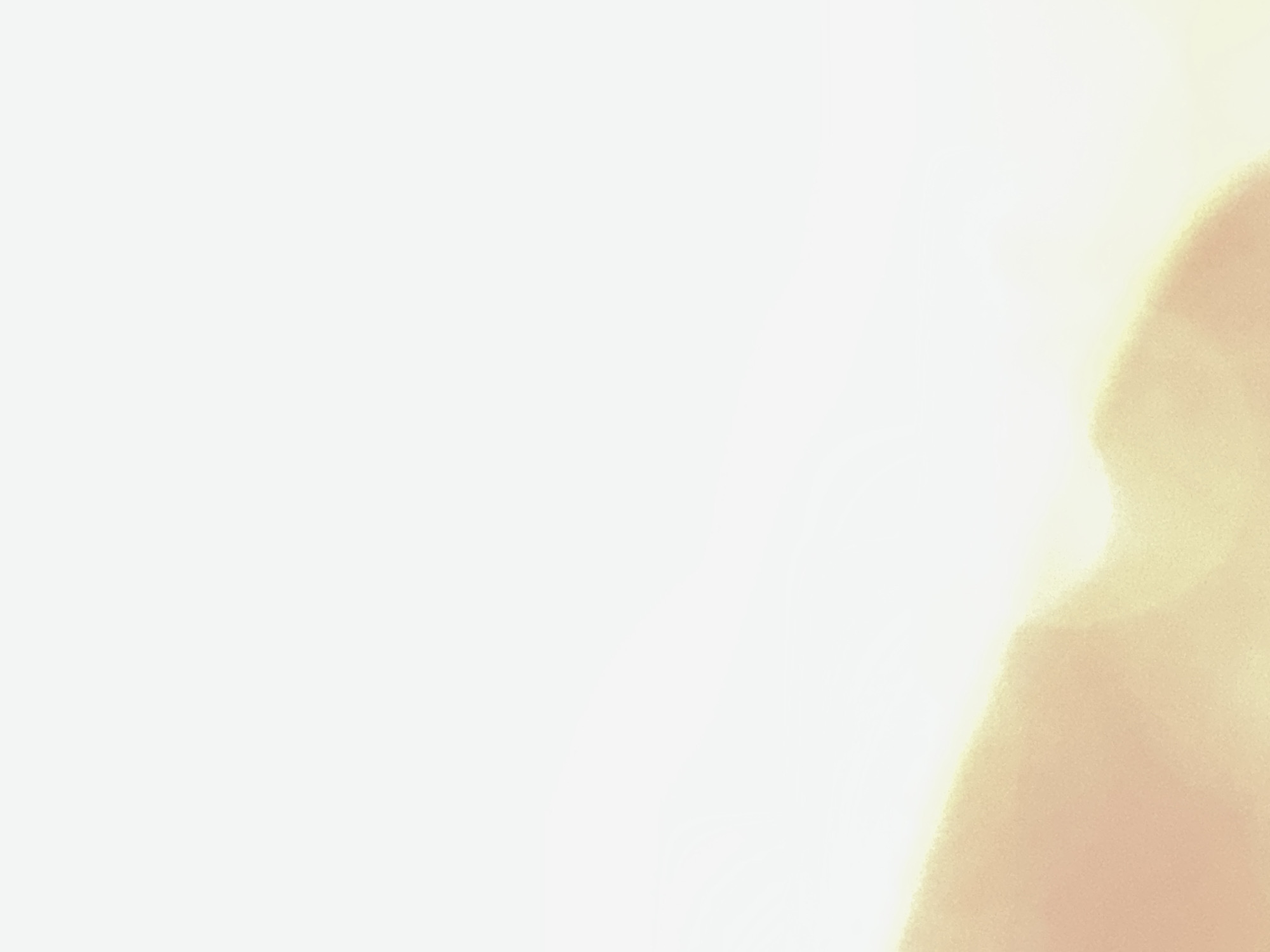 This is an abstract, digitally rendered image with soft, diffused light and a bokeh effect. The left side of the image is a bright, almost pure white, fading gradually to a pale yellow towards the right. The right side features a large, organic shape in a warm, peachy-orange hue, with its edges blurred and indistinct. This shape appears as if it's illuminated from behind, creating a glowing effect. There are no discernible subjects like people, objects, or a specific scene. The activity or event is not apparent. Notable details include the ethereal quality of the light and the soft blending of colors, which could evoke a sense of warmth, peace, or a dreamlike state. There is no visible text. The location context of Belgrade, Serbia, does not provide any specific cues within this abstract imagery.