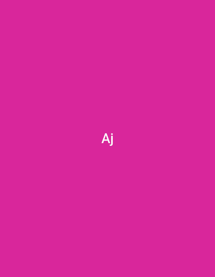The image displays a uniform magenta background. Centered horizontally and vertically, the white capital letters 'Aj' are prominently displayed. No people, objects, actions, interactions, or discernible environmental details are present in the visual content. The specified location for this description is the city of Casablanca, Morocco.