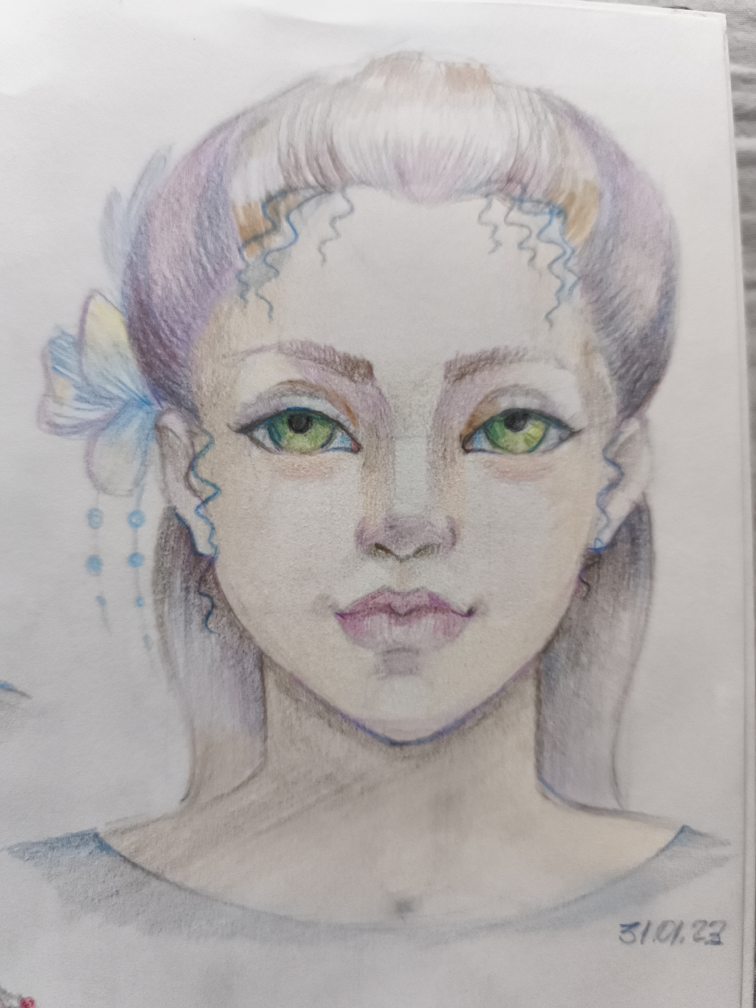 The image is a close-up, head-and-shoulders colored pencil drawing of a young woman with pale skin and large, bright green eyes. Her hair is styled up in a bun with strands of purple and blonde hair. She has delicate facial features, including thin eyebrows, a small nose, and slightly parted lips colored with pink. She wears a light blue garment around her neck and shoulders. Decorative elements include wavy blue lines on her forehead and ears, a light blue and yellow butterfly-like ornament behind her left ear with dangling blue beads, and what appears to be a faint sketch of a wing on the left side of the image. The drawing is signed in the bottom right corner with the date "31.01.23". The background is plain white paper, with some textural lines suggesting the paper's surface. The image does not depict any location in the city of Saint-Denis, France.