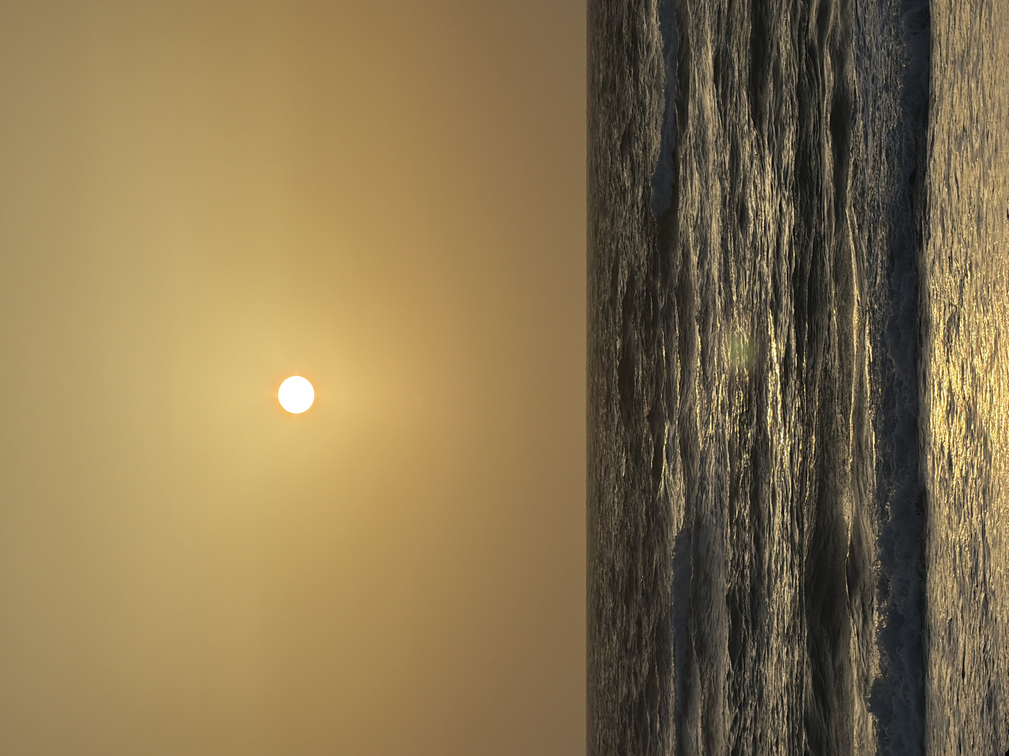 The image shows a sunset at the beach in Tel Aviv, Israel. On the left, a pale yellow sky is dominated by a bright sun, positioned slightly above the center. To the right, there's a vertical band of ocean waves, reflecting the golden sunlight. The water has a textured appearance due to the waves. The photograph is oriented sideways with the sky being on the left and the ocean on the right.