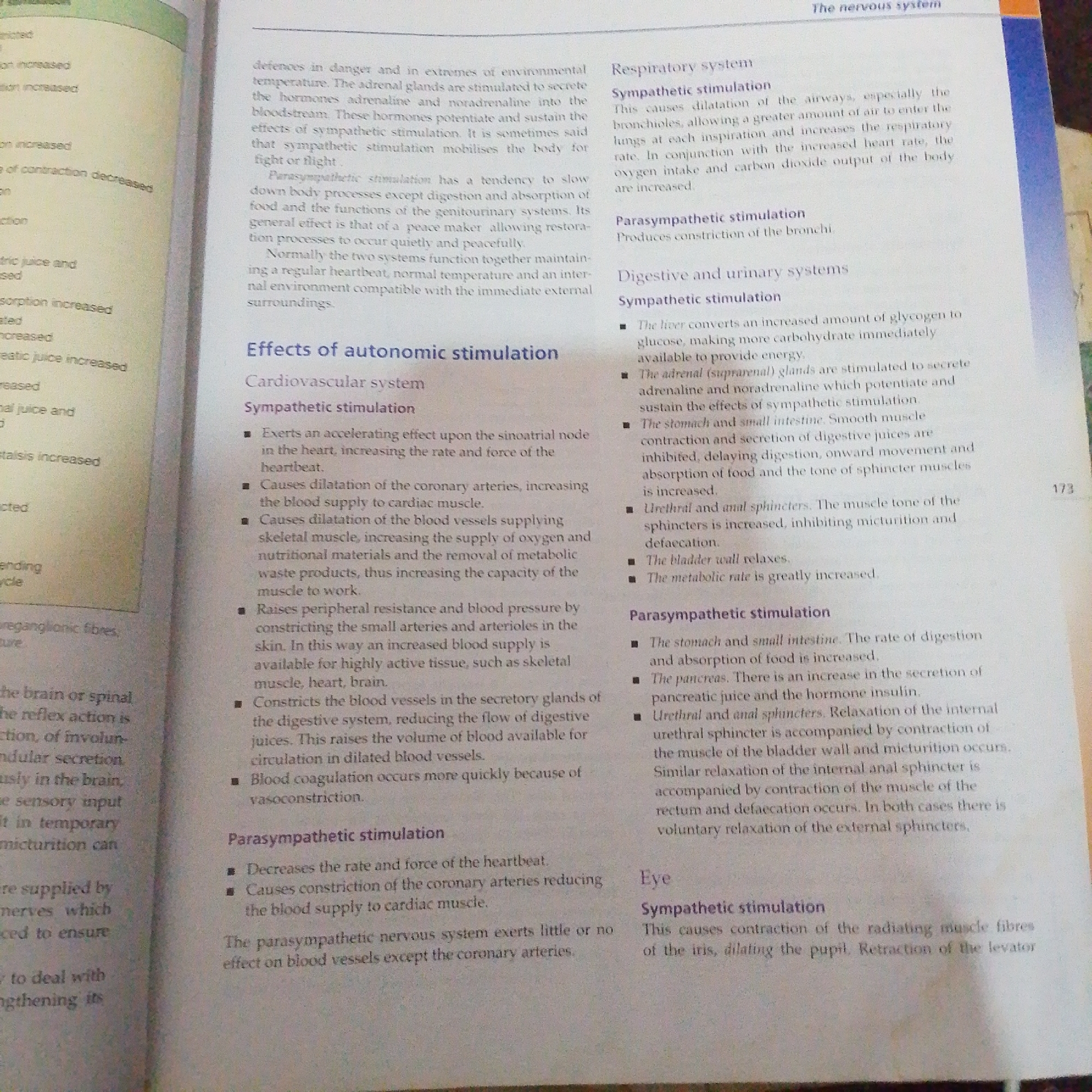 The image is a close-up, high-angle, well-lit, full shot of an open textbook page. The text on the page discusses the effects of autonomic stimulation on various bodily systems, including the respiratory, digestive, urinary, and cardiovascular systems, as well as the eye. The text is divided into sections with headings such as "Effects of autonomic stimulation," "Cardiovascular system," "Respiratory system," and "Eye." Bullet points are used to list the specific effects of sympathetic and parasympathetic stimulation. The page appears to be from a biology or anatomy textbook, with the number "173" visible on the right side of the page. There are no people, objects, or environmental elements present in the image beyond the textbook itself. The location of Jalingo, Nigeria, is not relevant to the content of the image.