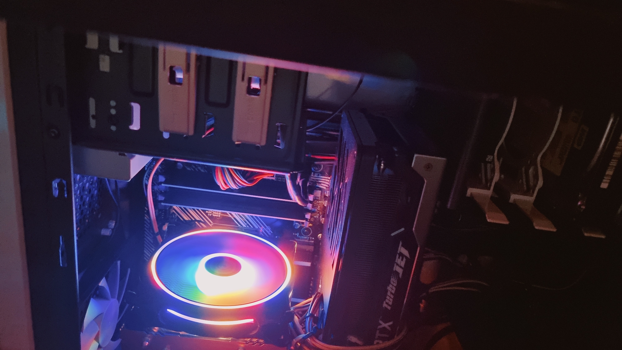 The image shows the inside of a computer tower case. The main components visible are a CPU cooler with RGB lighting, a graphics card labeled "RTX Turbo JET," and RAM modules. Various cables are also visible within the case. The setting is likely indoors and the location in Dunnae-myeon, South Korea is not determinable from the image itself.