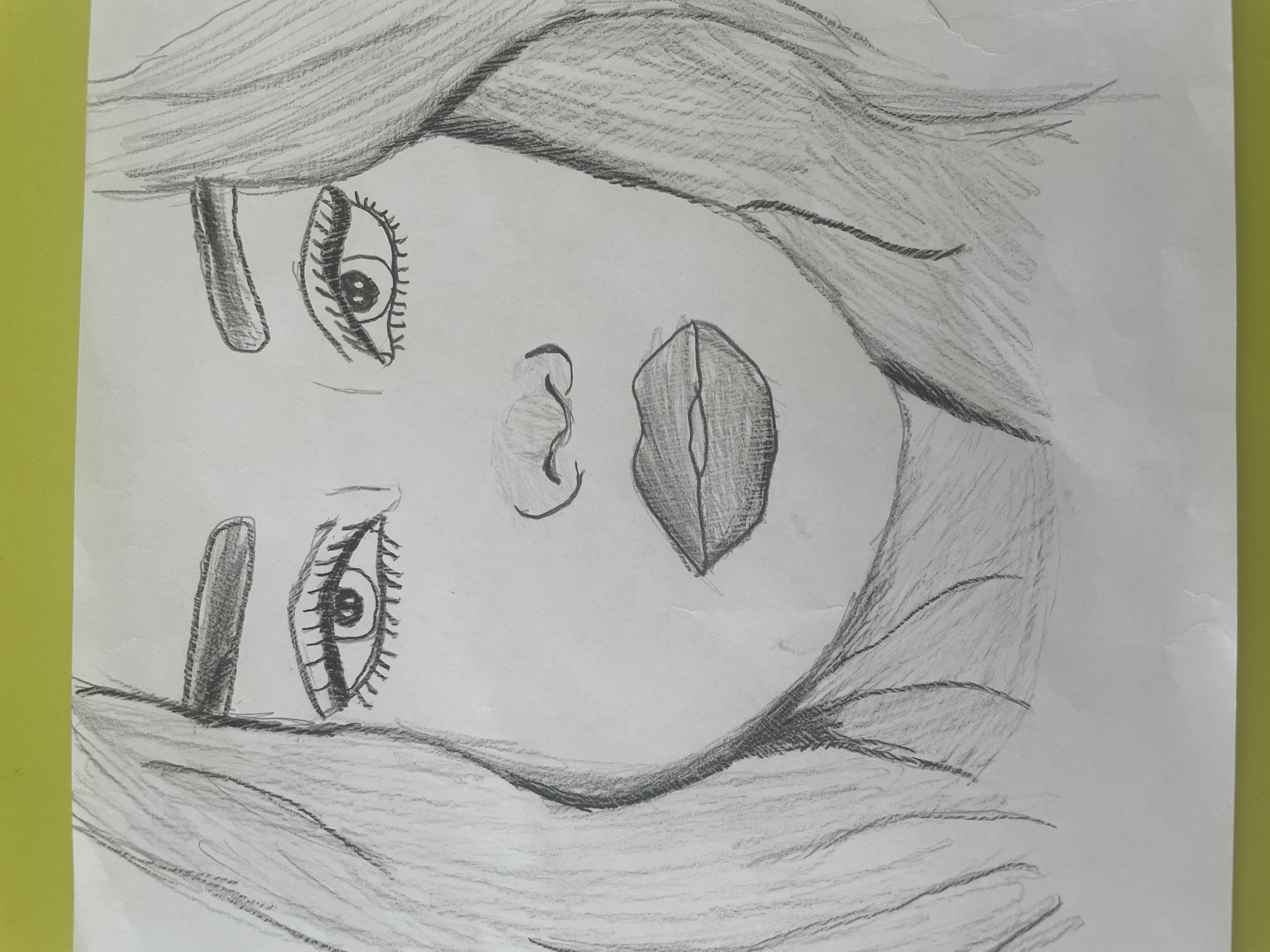A pencil sketch of a woman's face, oriented on its side. The sketch depicts the woman from the eyebrows down, including two eyes with eyelashes, a nose, and lips. The hair frames the face. There is no indication this image is in Saratov, Russia.