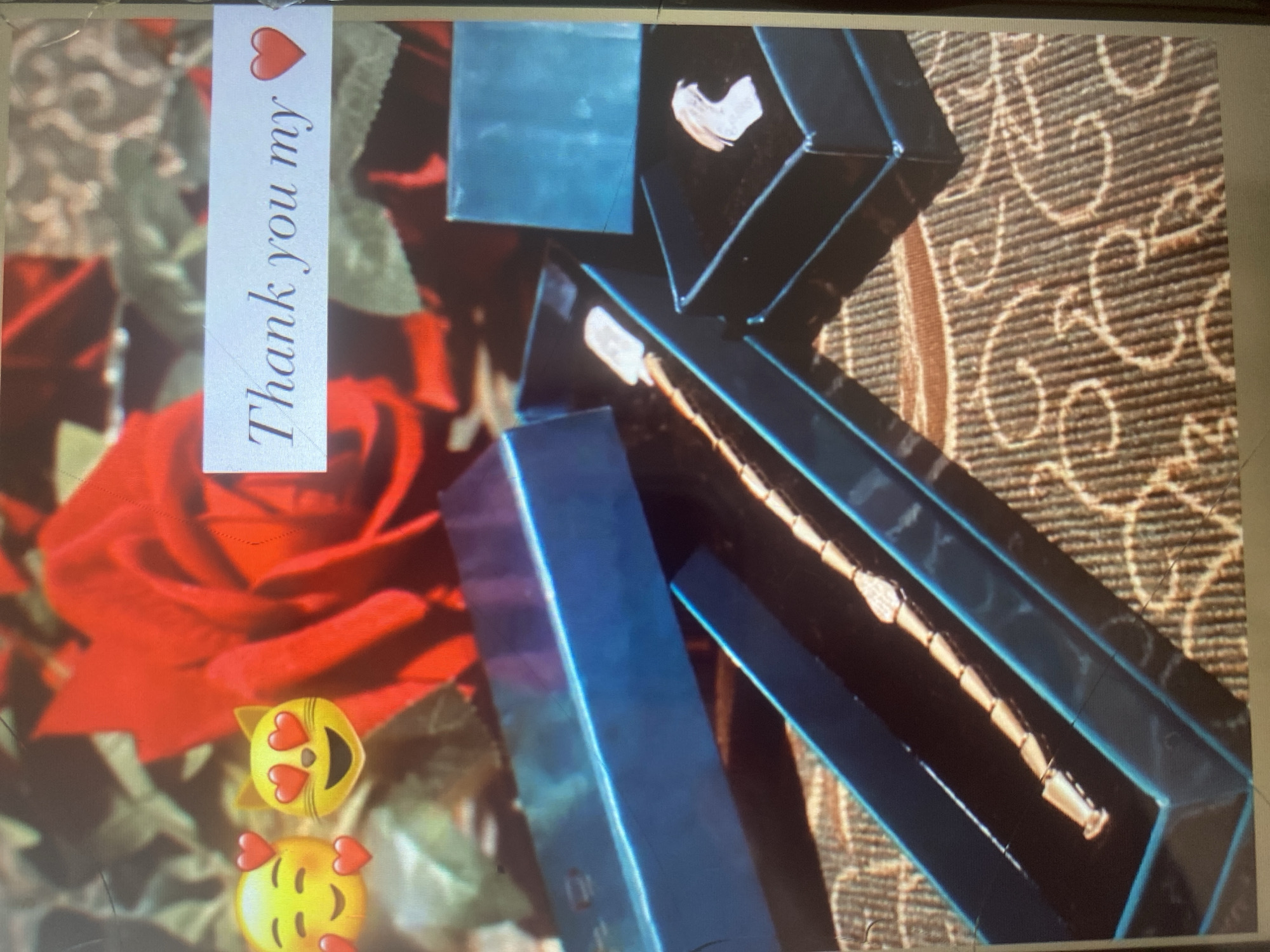 This image depicts a close-up view of a gift presentation, likely a jewelry item, set against a backdrop of red roses. In the foreground, there are two open gift boxes, one dark blue and the other black. Inside the dark blue box, a delicate, segmented bracelet or necklace is displayed on a black velvet lining. The black box contains a single, light-colored, intricately designed ring.
A white rectangular sticker overlaying the roses features text in a cursive font that reads, "Thank you my" followed by a red heart emoji. To the left of the text, two emoji faces are superimposed on the image: one with closed eyes and rosy cheeks, and another cat face with heart-shaped eyes. The background is dominated by large, vibrant red roses with green foliage, suggesting a romantic or celebratory occasion. The overall impression is one of gratitude and a thoughtful gift.
There is no visible indication of the city of Arbagish, Uzbekistan, or any specific urban environment. The scene is focused on the gifts and the accompanying message.