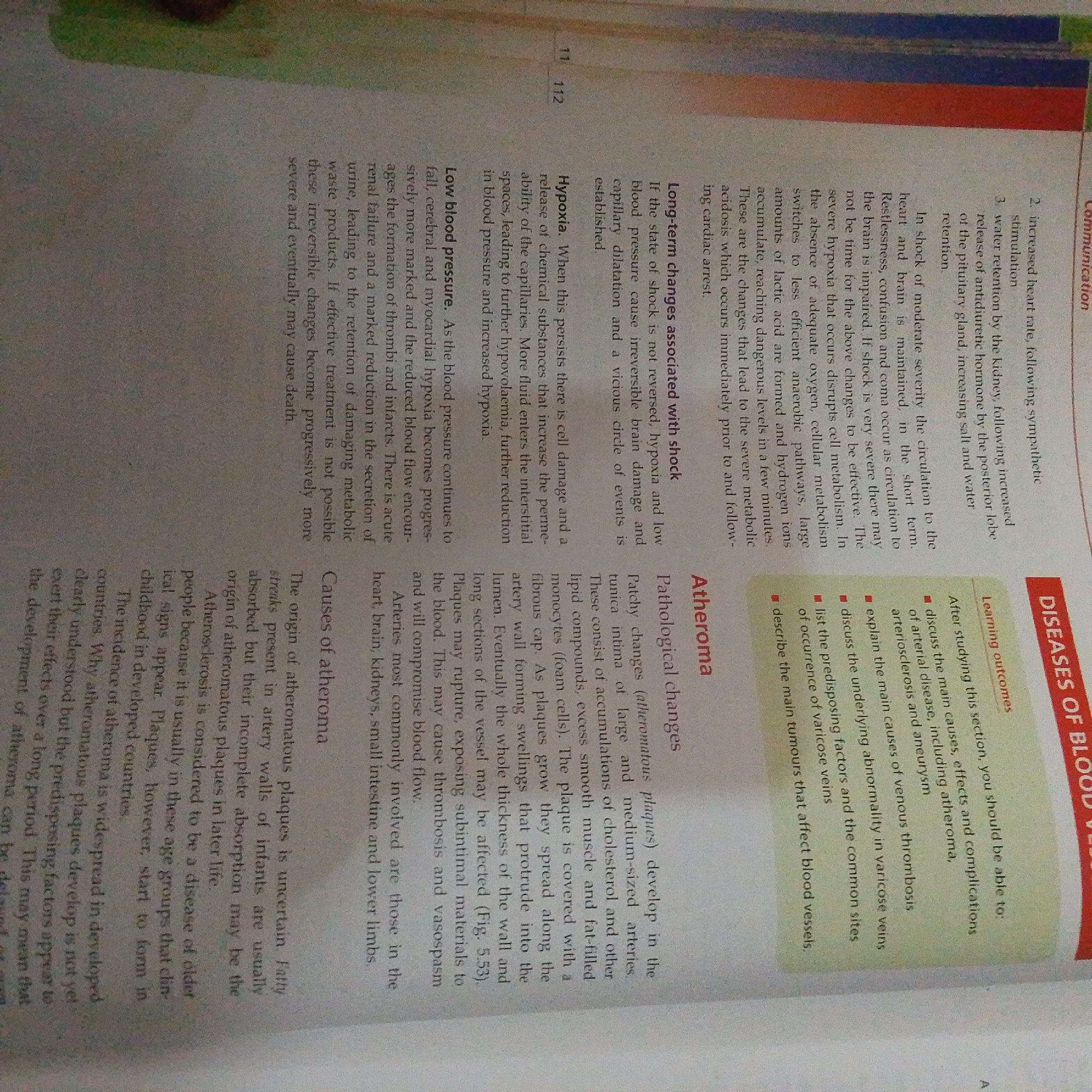 The image is a photograph of an open textbook page, likely from a biology or health science curriculum. The page is densely packed with text, organized into distinct sections with headings such as "Communication," "DISEASES OF BLOOD," "Pathological changes," "Causes of atheroma," and "Learning outcomes." The text discusses medical conditions related to blood vessels, including shock, hypoxia, low blood pressure, and atheroma.
There are no people, objects, or a specific scene depicted in the image. The setting is a plain, off-white page with black text, and some colored sections, including a red bar with white text on the right side of the page that reads "DISEASES OF BLOOD." The time of day, weather, and location cues are not discernible from the image itself. The text is factual and informative, describing physiological processes and diseases. No emotions are conveyed as the image is purely informational.
The visible text includes numbered points (e.g., "2. increased heart rate," "3. water retention"), bullet points within the "Learning outcomes" section, and descriptive paragraphs. The page numbers "11" and "112" are visible at the top of the page. The context of "Jalingo, Nigeria" is not visually represented in the image but is provided as external information for describing the media file.