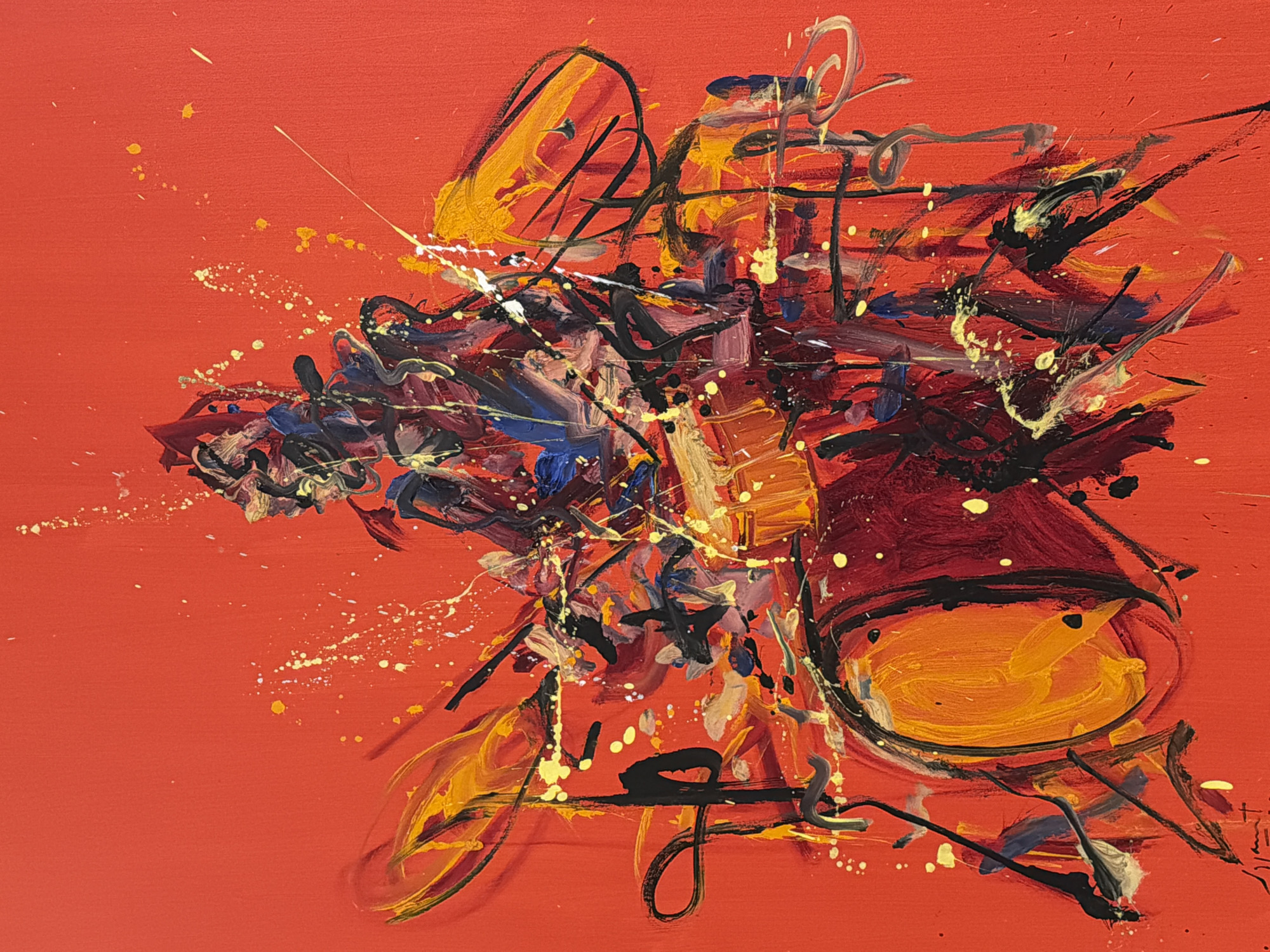 This is an abstract painting on a red canvas, depicting a drummer in action. The figure of the drummer is rendered with energetic, gestural strokes of dark colors like black, deep red, and blue, mixed with highlights of yellow and white. The drummer's posture suggests intense movement, with limbs blurred and contorted. Surrounding the drummer are abstract representations of drum kit elements, including a large bass drum on the left, painted in shades of dark red and orange, and cymbal-like shapes in yellow and orange on the sides. Splatters and drips of yellow and white paint are scattered across the canvas, adding to the dynamic and chaotic feel of the piece, evoking the intensity of a musical performance. The background is a solid, vibrant red, which makes the colorful and energetic brushwork of the subject stand out prominently. There is a faint, illegible signature in the bottom left corner. The artwork does not depict any recognizable San Bernardino Tlaxcalancingo landmarks or environments.