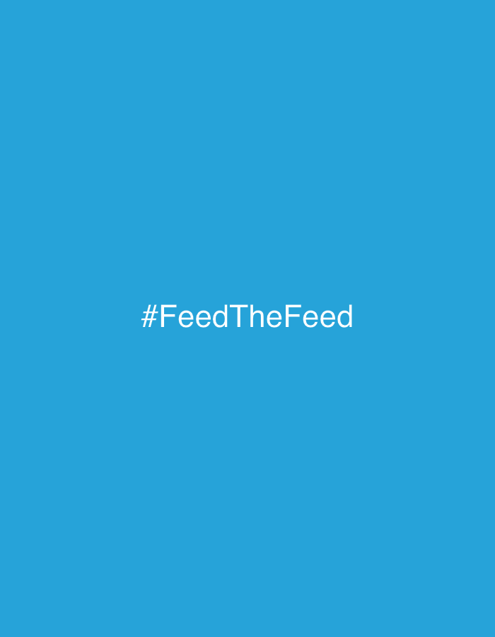 The image displays a uniform, solid blue background. Centered horizontally and vertically within this blue field is white sans-serif text reading "#FeedTheFeed". No other subjects, objects, people, actions, interactions, or environmental details are visible. There is no discernible information within the image to indicate a specific location in Tel-Aviv, Israel, or any other geographical area.